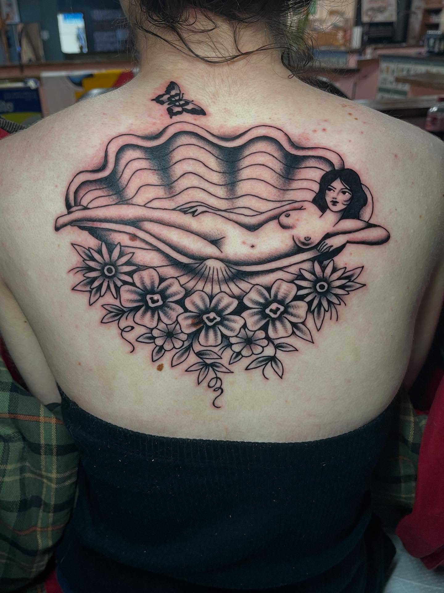 Nude woman with flowers realism tattoo on the back by Marqui Watling