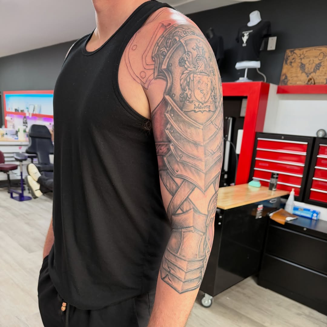 Armor and shield realism tattoo on the upper arm by Jinx Ryder