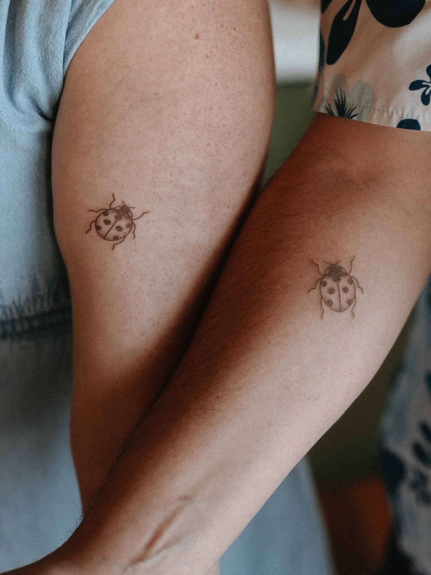 Ladybug black and grey tattoo on the forearm by Grace Wise - Handpoke Tattoos