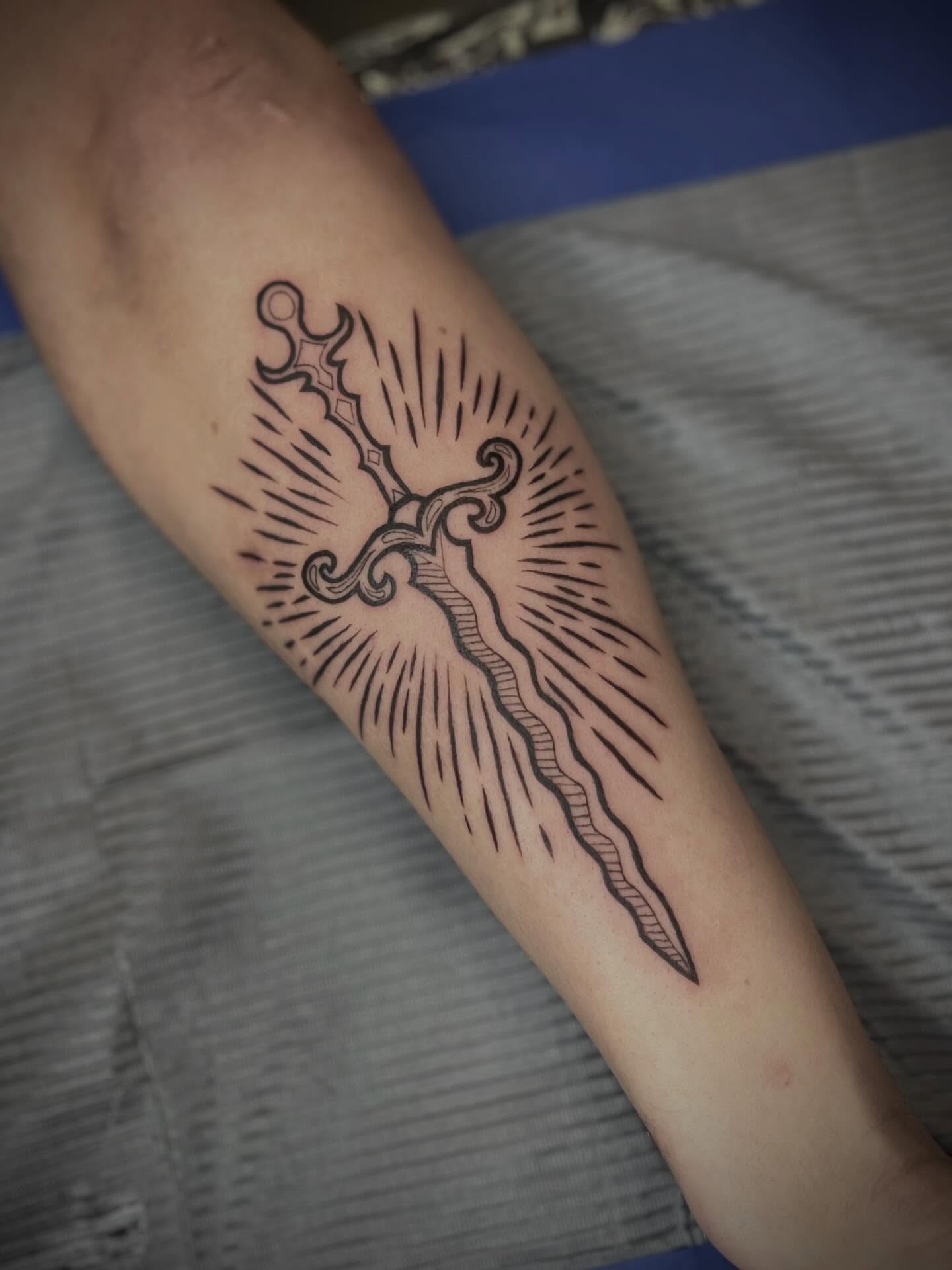 Sword black and grey tattoo on the forearm by Lexi Rose
