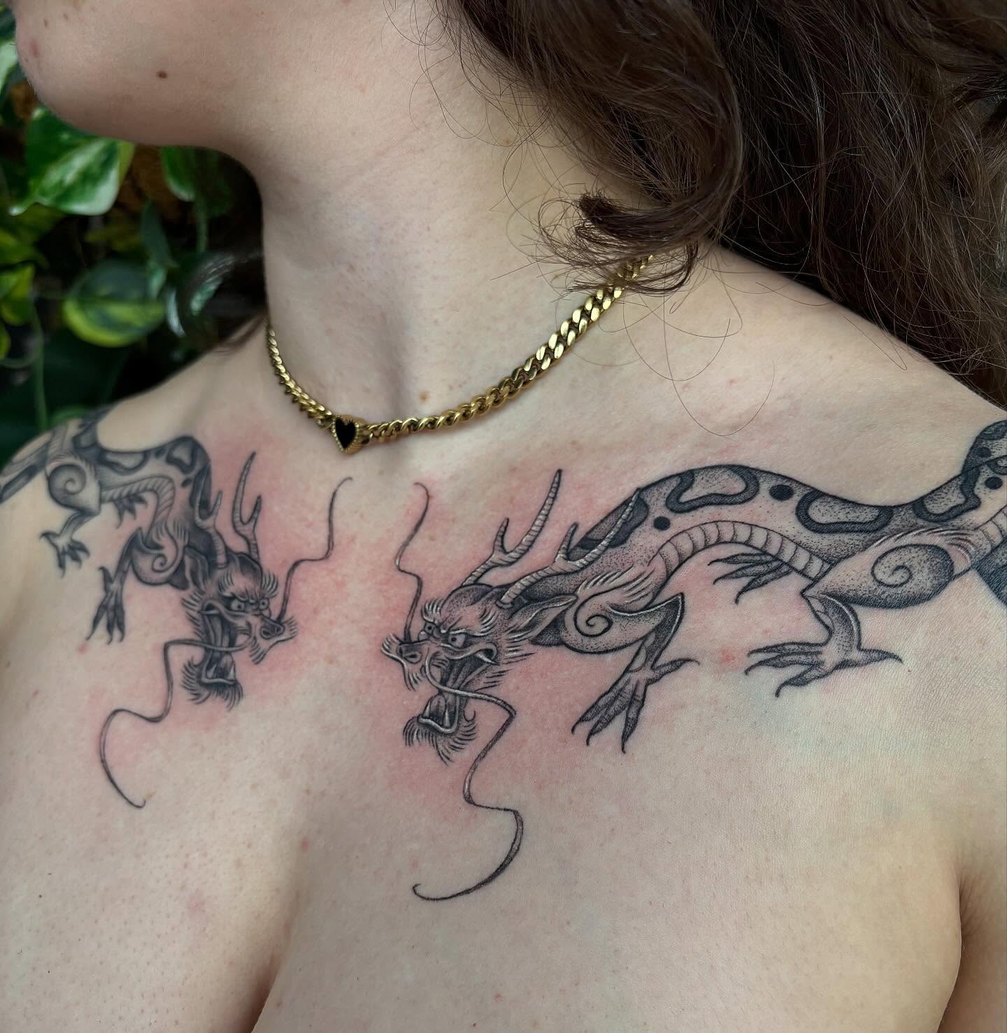 Dragons black and grey tattoo on the chest by Hailey Nicole