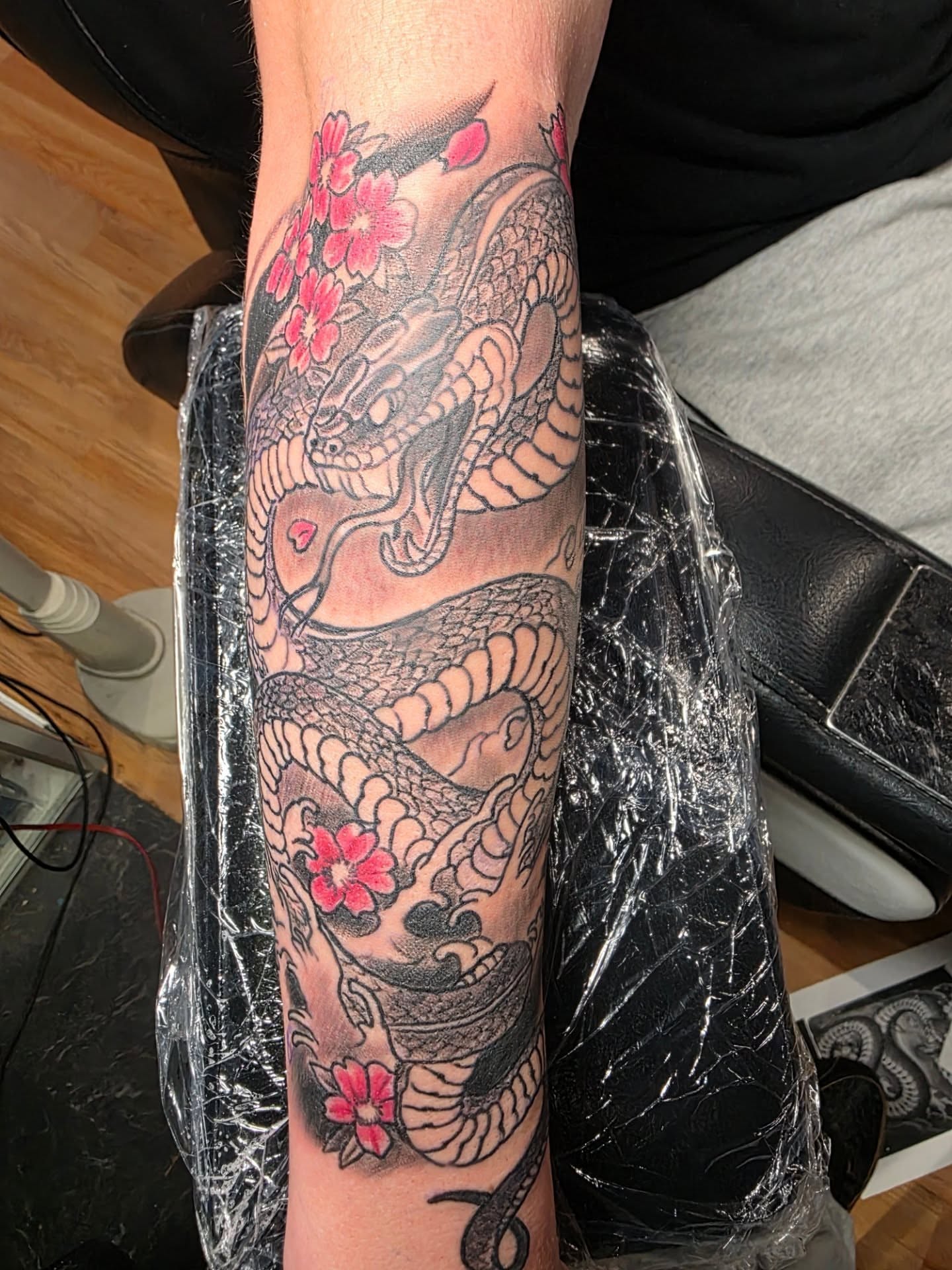 Dragon and cherry blossoms japanese irezumi tattoo on the forearm by Rusty Williams