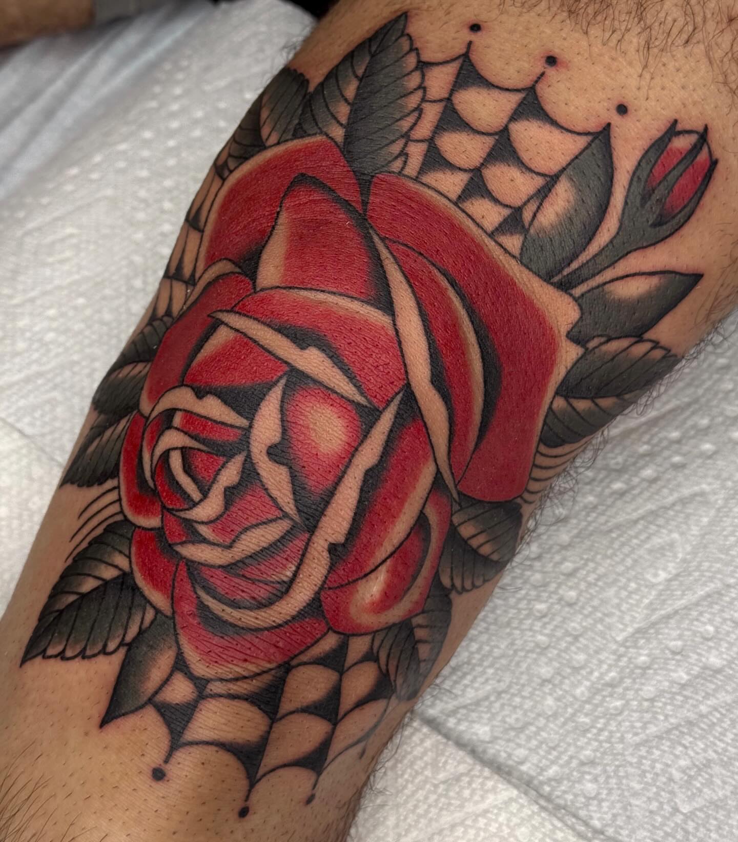 Red rose American traditional tattoo on the forearm by Bridgette Carberry