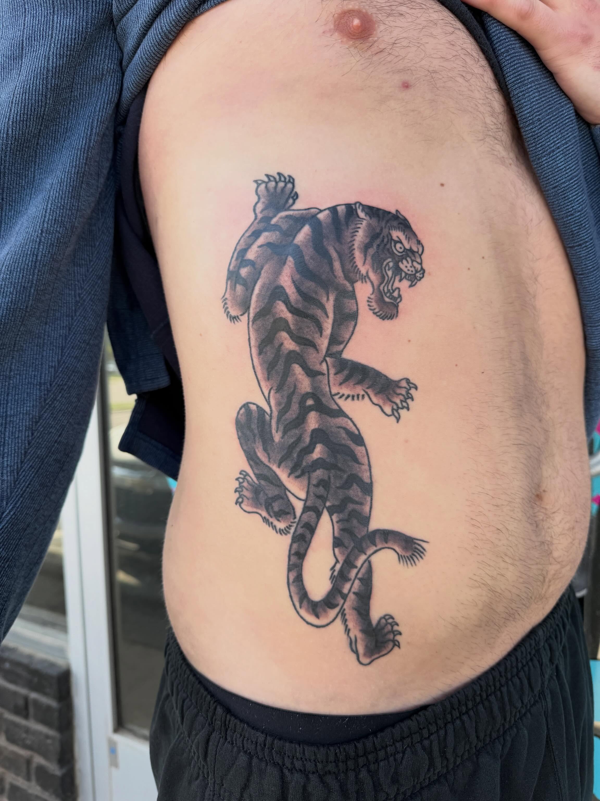 Tiger black and grey tattoo on the ribs by Ali Calis