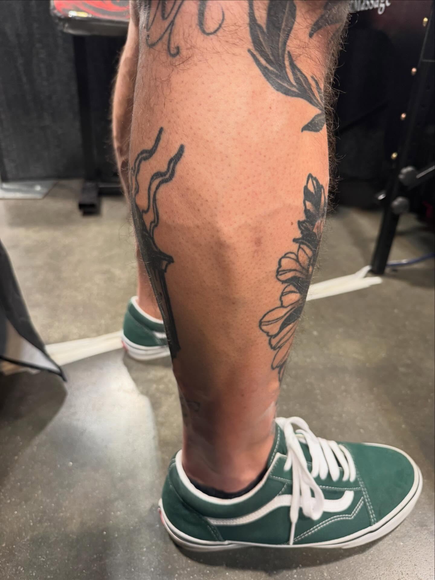 Flower and vine black and grey tattoo on the calf by Dustin Kaiser, Mentor, Ohio