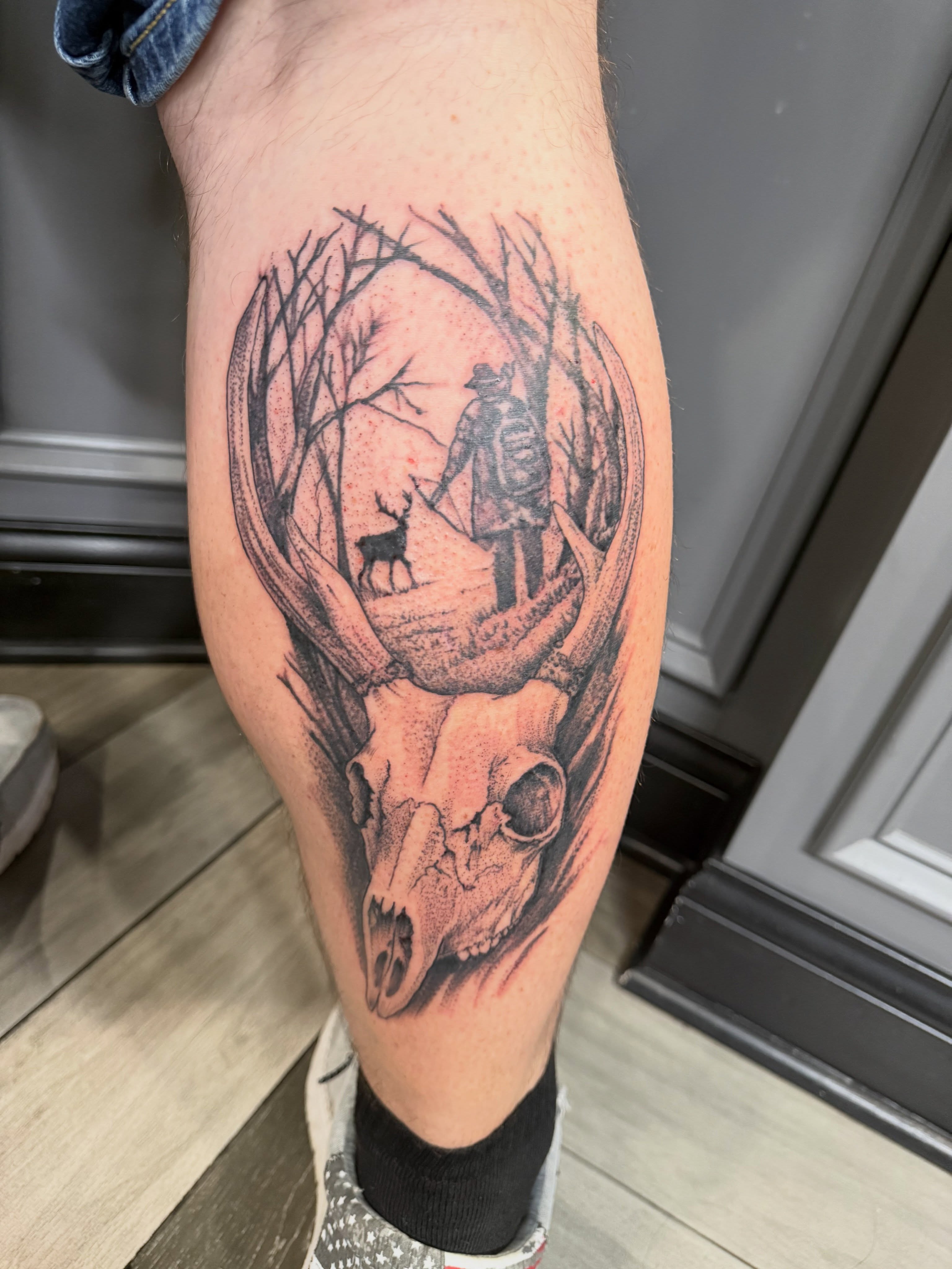 Deer skull with hunter and deer dotwork tattoo on the thigh by Dave Potavin, Erlanger, Kentucky
