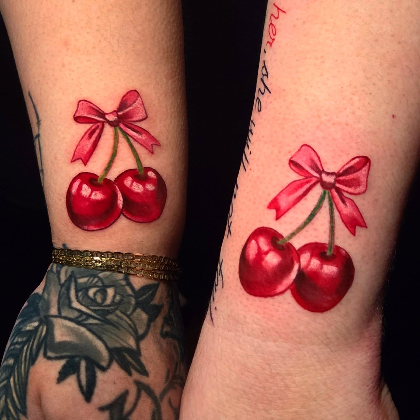 Cherries with bow realism tattoo on the forearm by Jack Jr Mora
