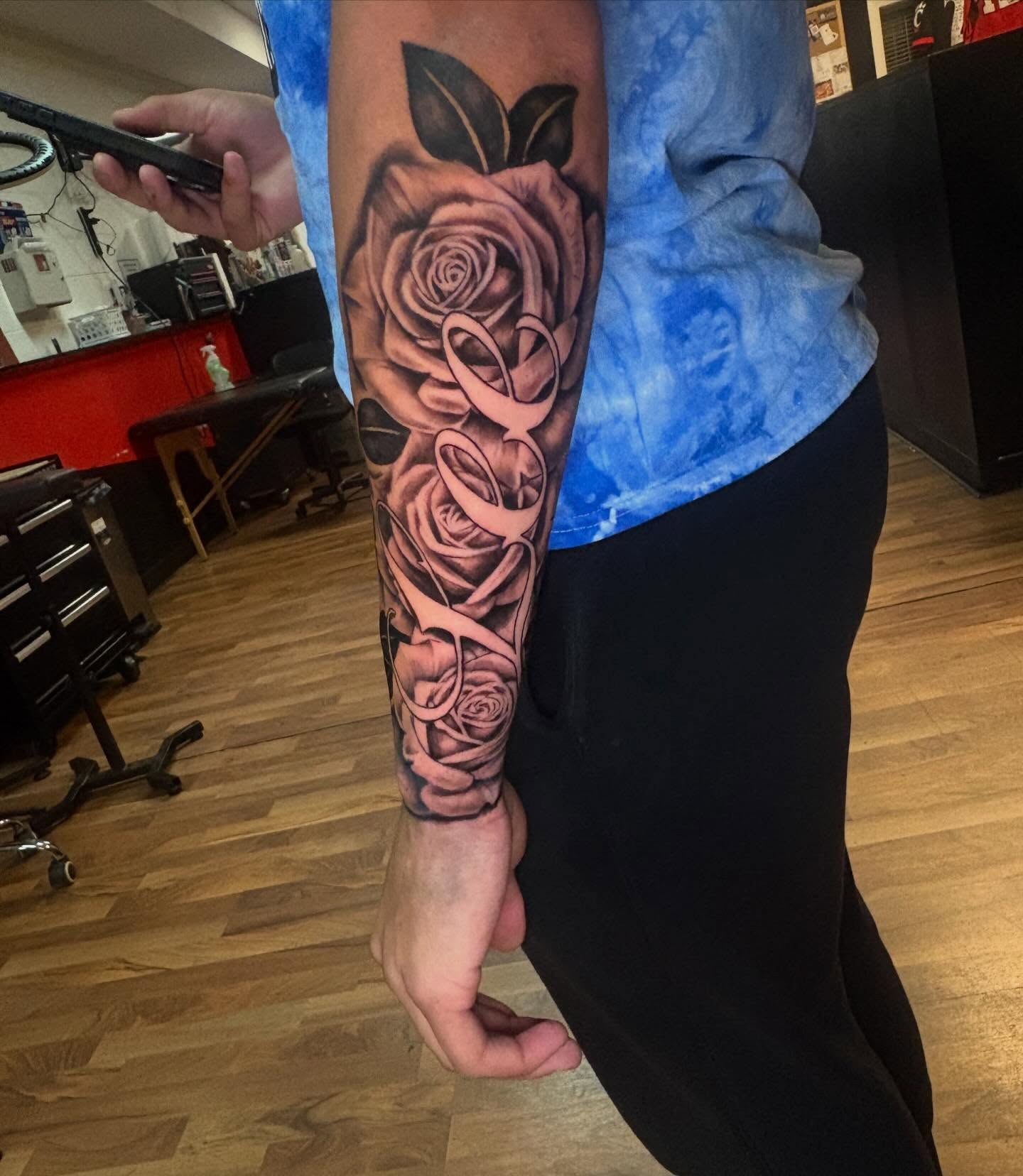 Roses and script realism tattoo on the forearm by 𓂀 𝕊ℍ𝔼𝕃𝕃𝕐 𓂀