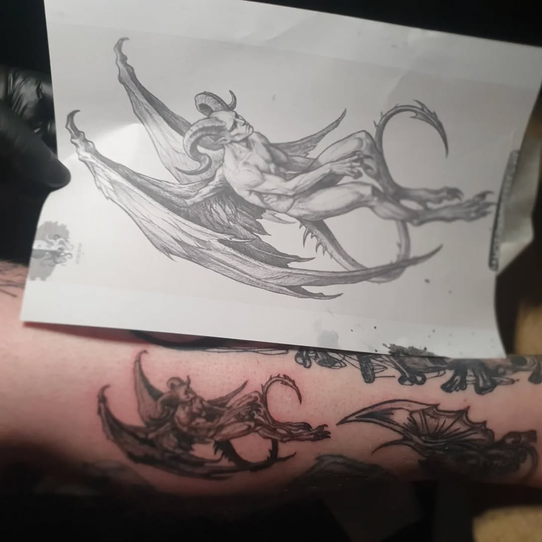 Demon with wings realism tattoo on the forearm by Artful Ink