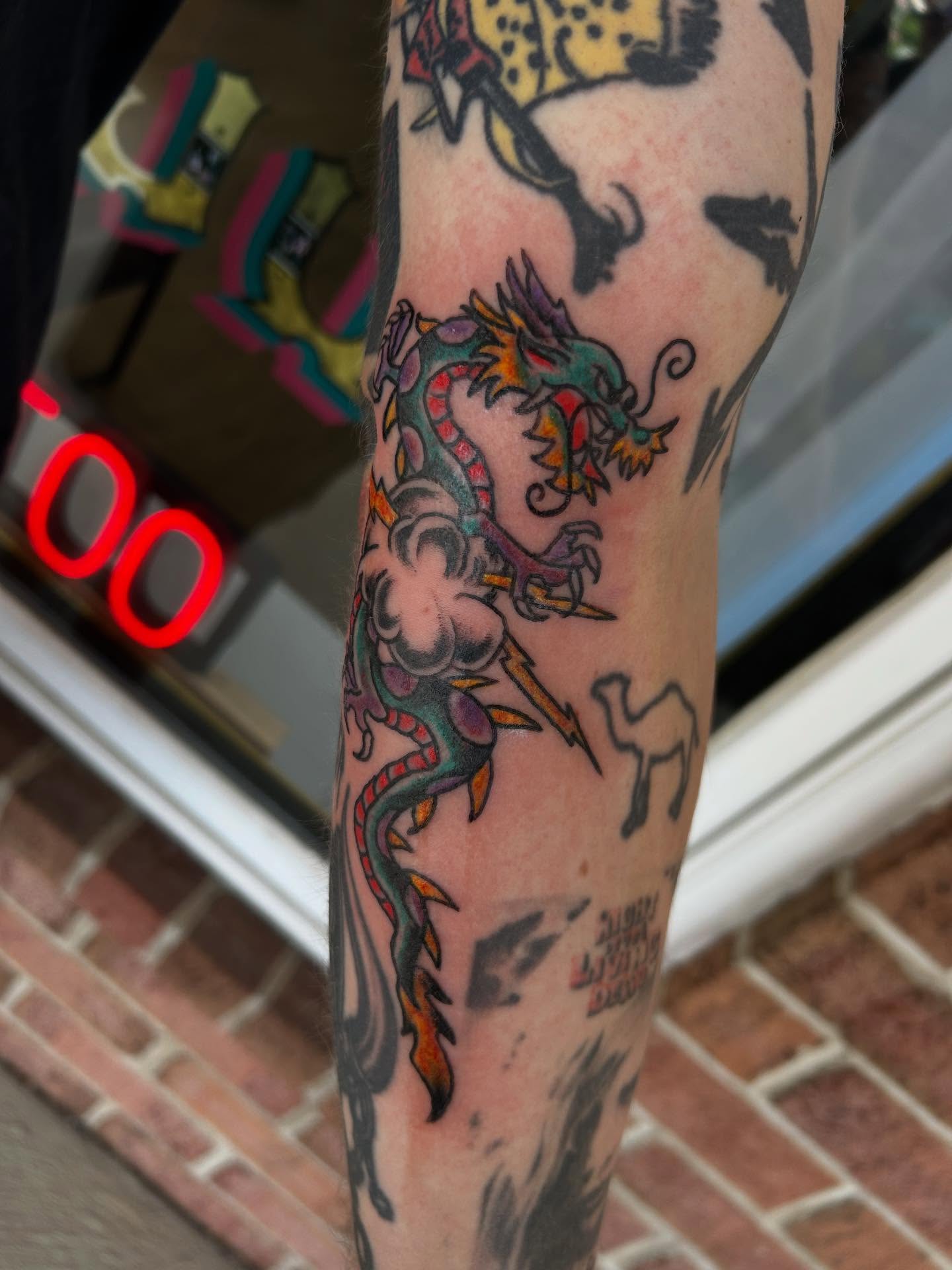 Dragon American traditional tattoo on the forearm by Stogie Tony