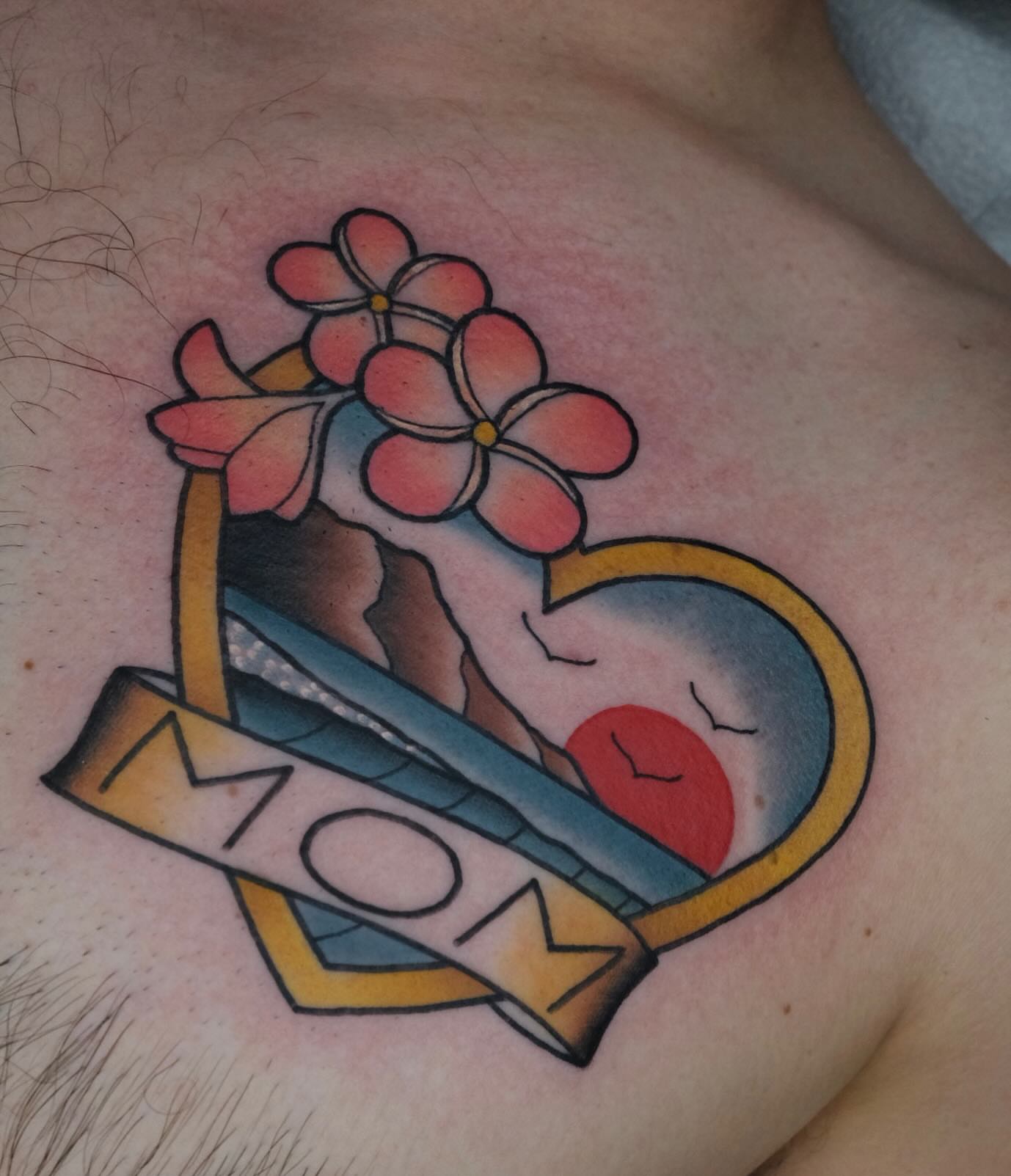 Flower and heart American traditional tattoo on the chest by James Maxwell