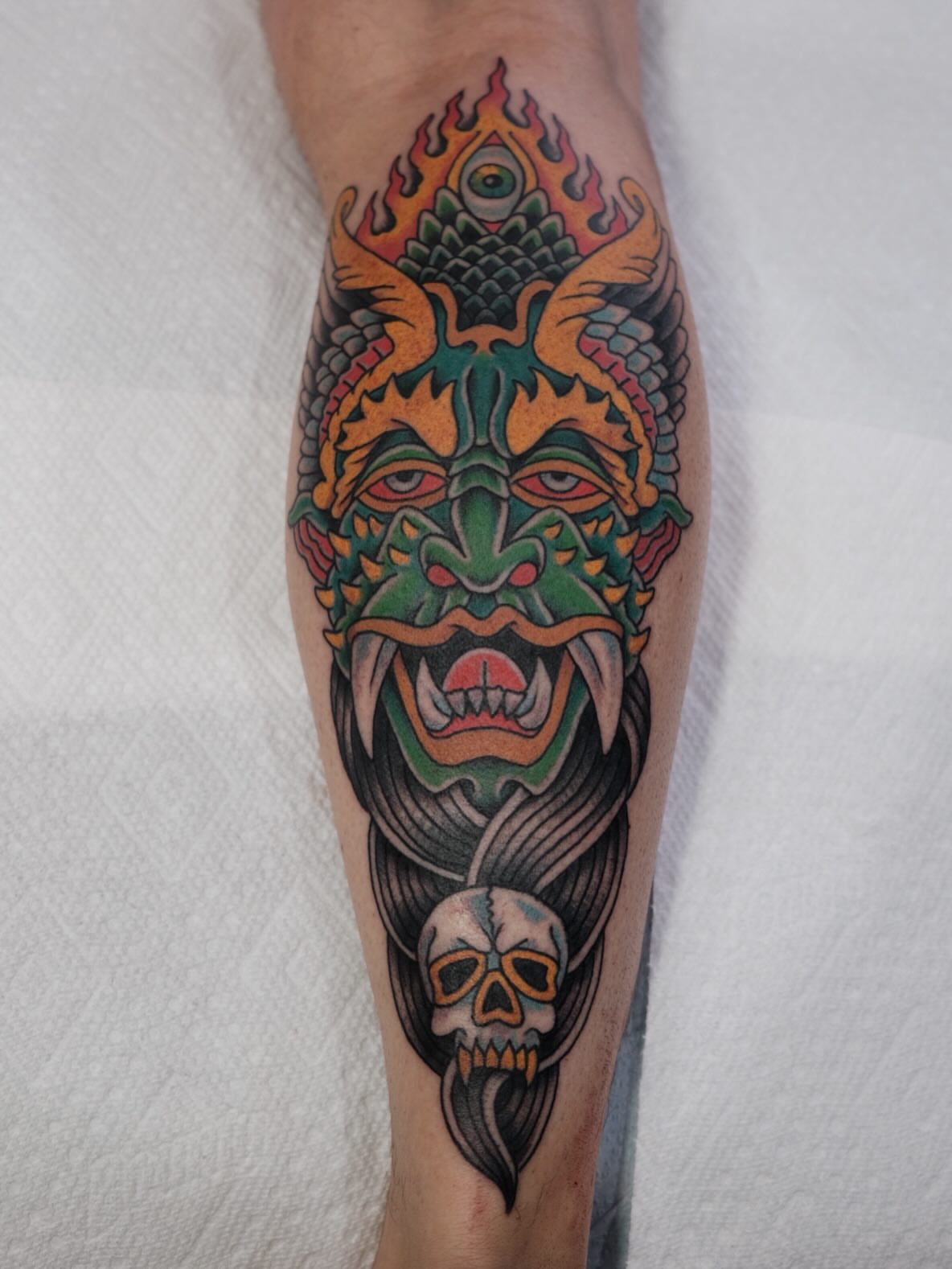 Demon mask American traditional tattoo on the forearm by Zak Colburn