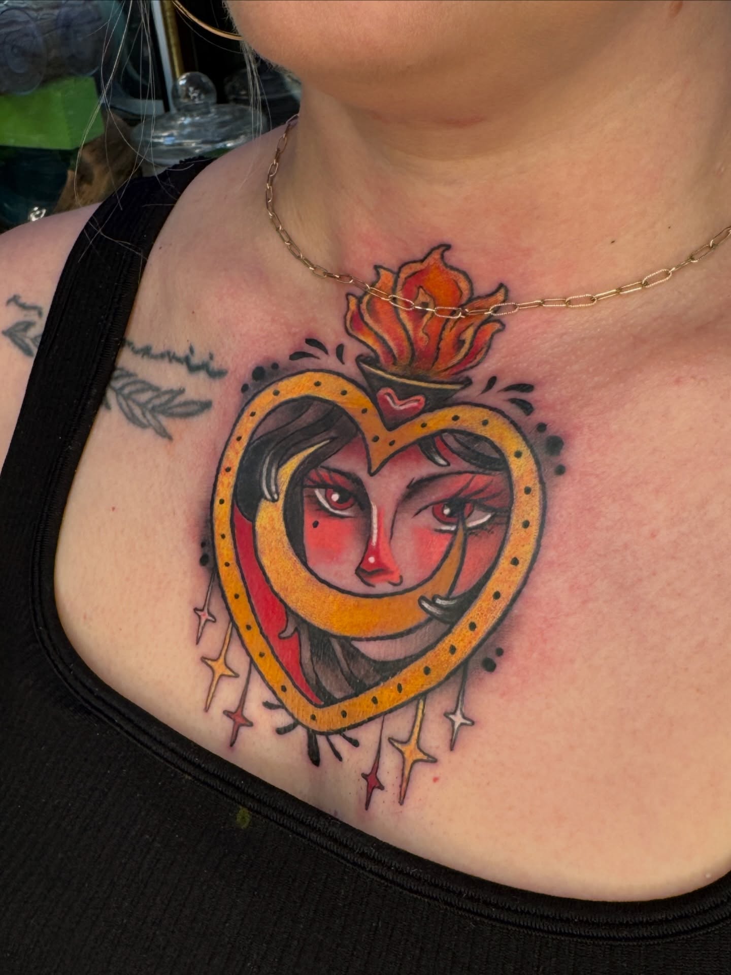 Heart with woman's face American traditional tattoo on the chest by Tattoos by Angel Lee