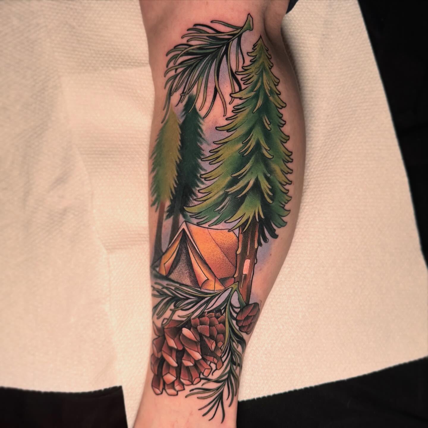 Pine trees and tent American traditional tattoo on the forearm by 🕯Heather🕯