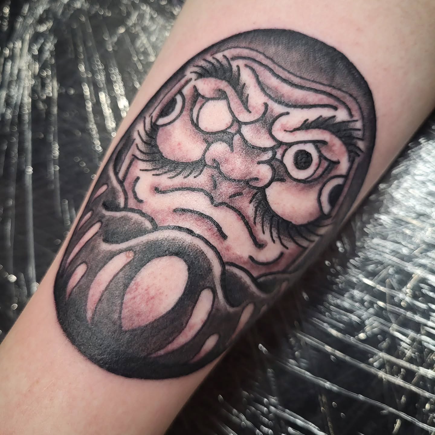 Mask black and grey tattoo on the forearm by Sloan Smith