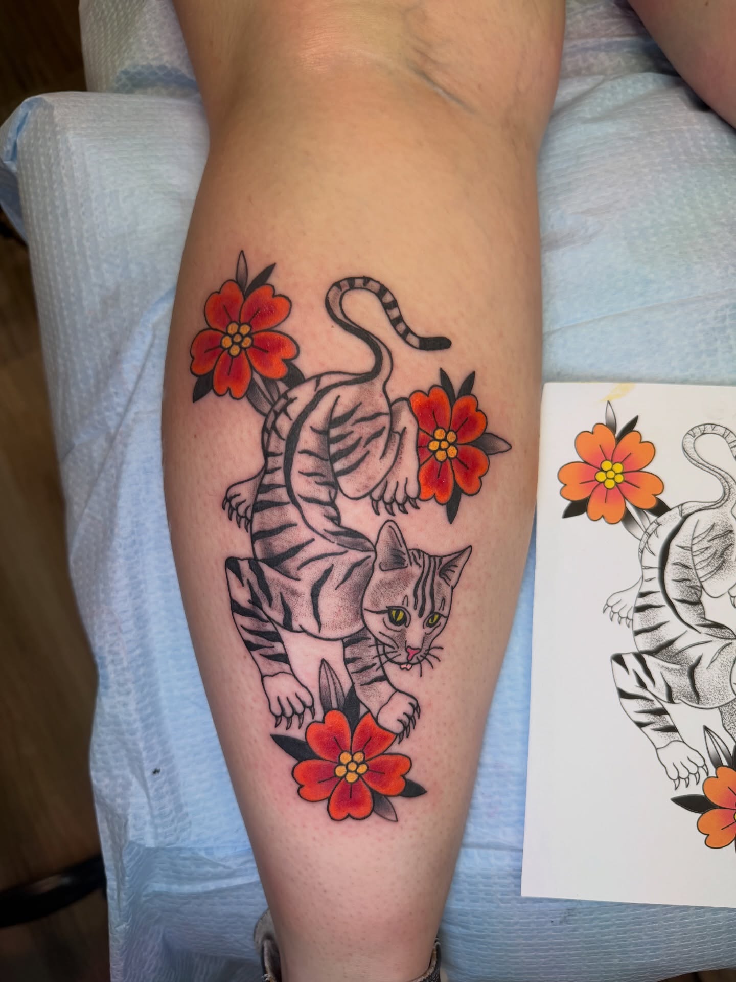Cat and flowers American traditional tattoo on the forearm by McKenna