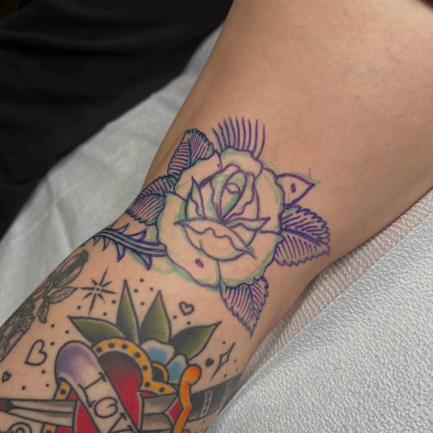 Rose American traditional tattoo on the forearm by Andrew Storm