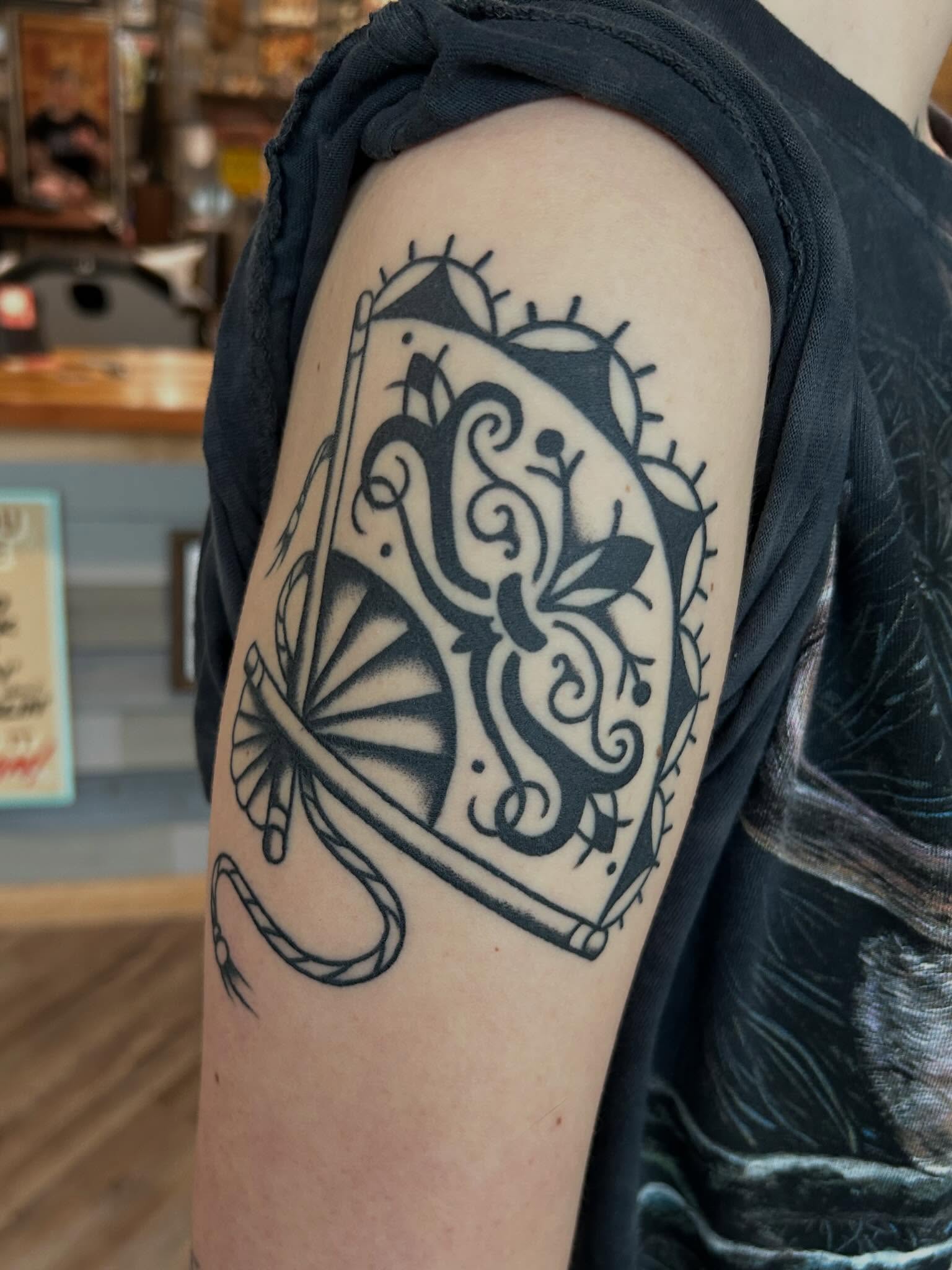 Fan and dragon black and grey tattoo on the shoulder by Morgan Mansfield