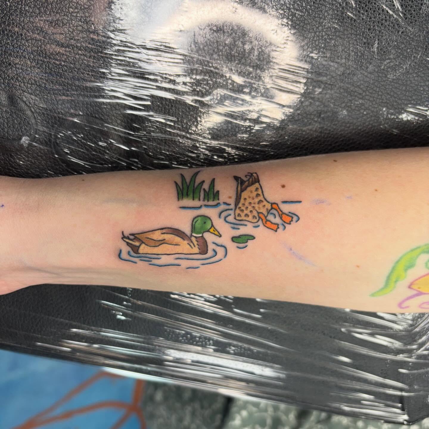 Duck and duckling new school tattoo on the forearm by Cam Sykes