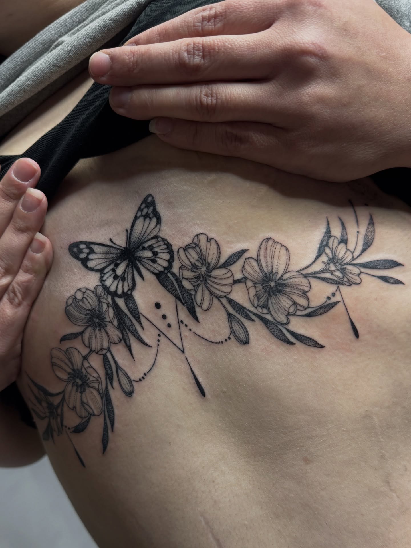Butterfly and flowers black and grey tattoo on the shoulder by Saffron Florea, Tiffin, Ohio