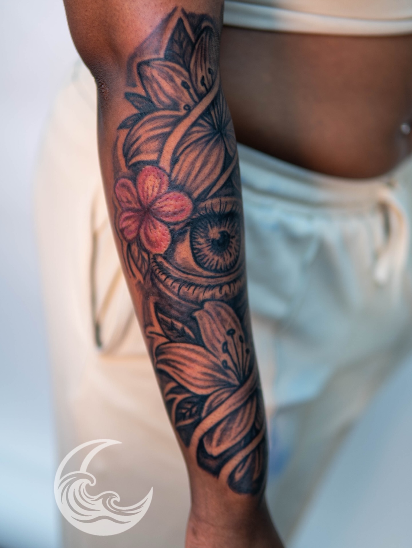 Eye and flowers realism tattoo on the forearm by Justin custard Tattoo💉Artist 🎨Painter