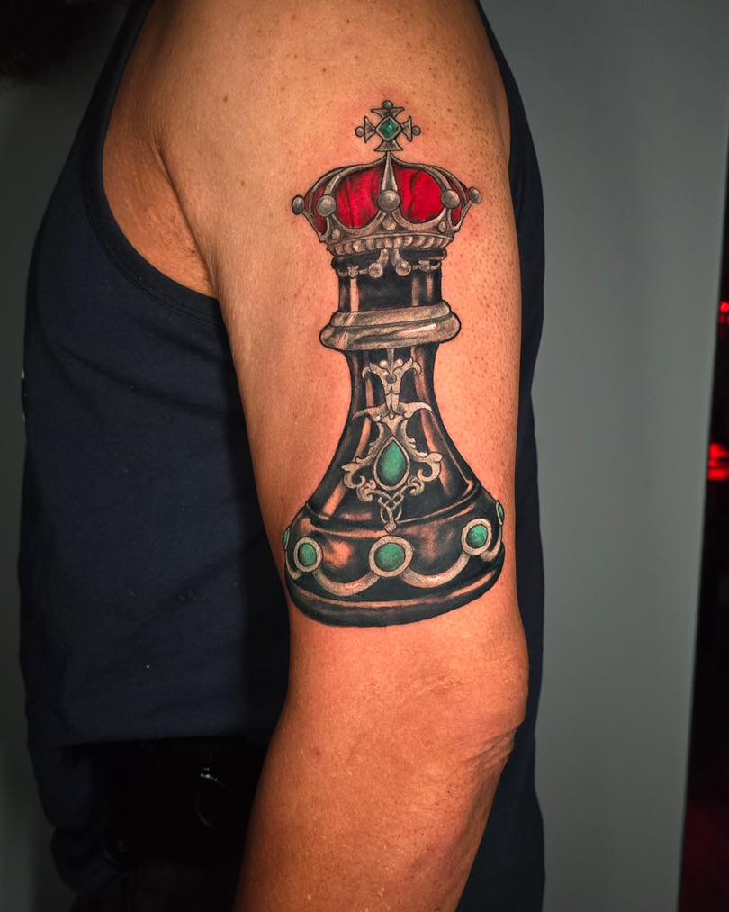 King chess piece realism tattoo on the forearm by Tank Maass