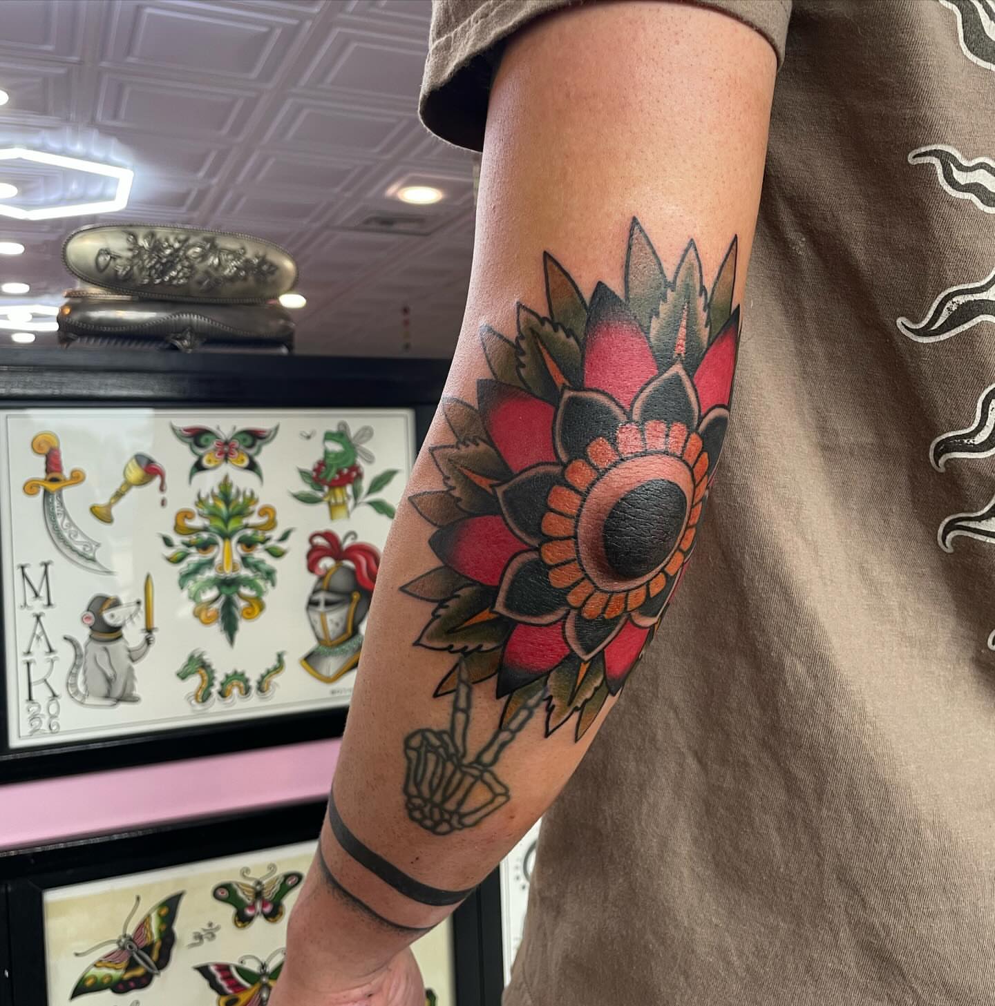 Flower American traditional tattoo on the forearm by Lainy Lou
