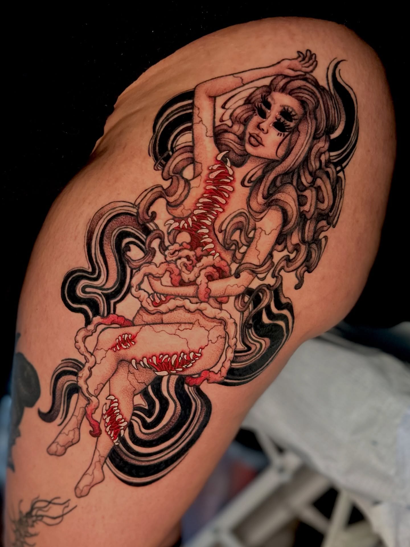 Woman with flowing hair illustrative tattoo on the thigh by Ghost