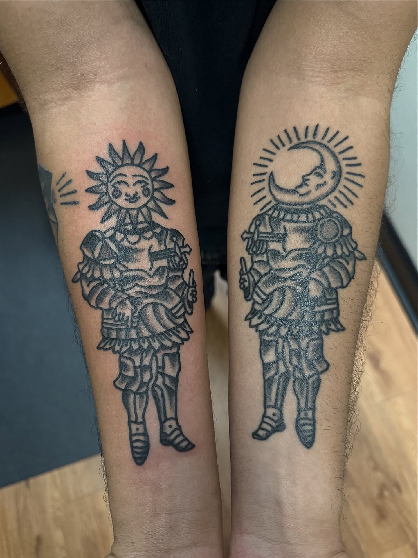 Sun and moon figures black and grey tattoo on the forearm by @kevingaretz, Jersey City, New Jersey