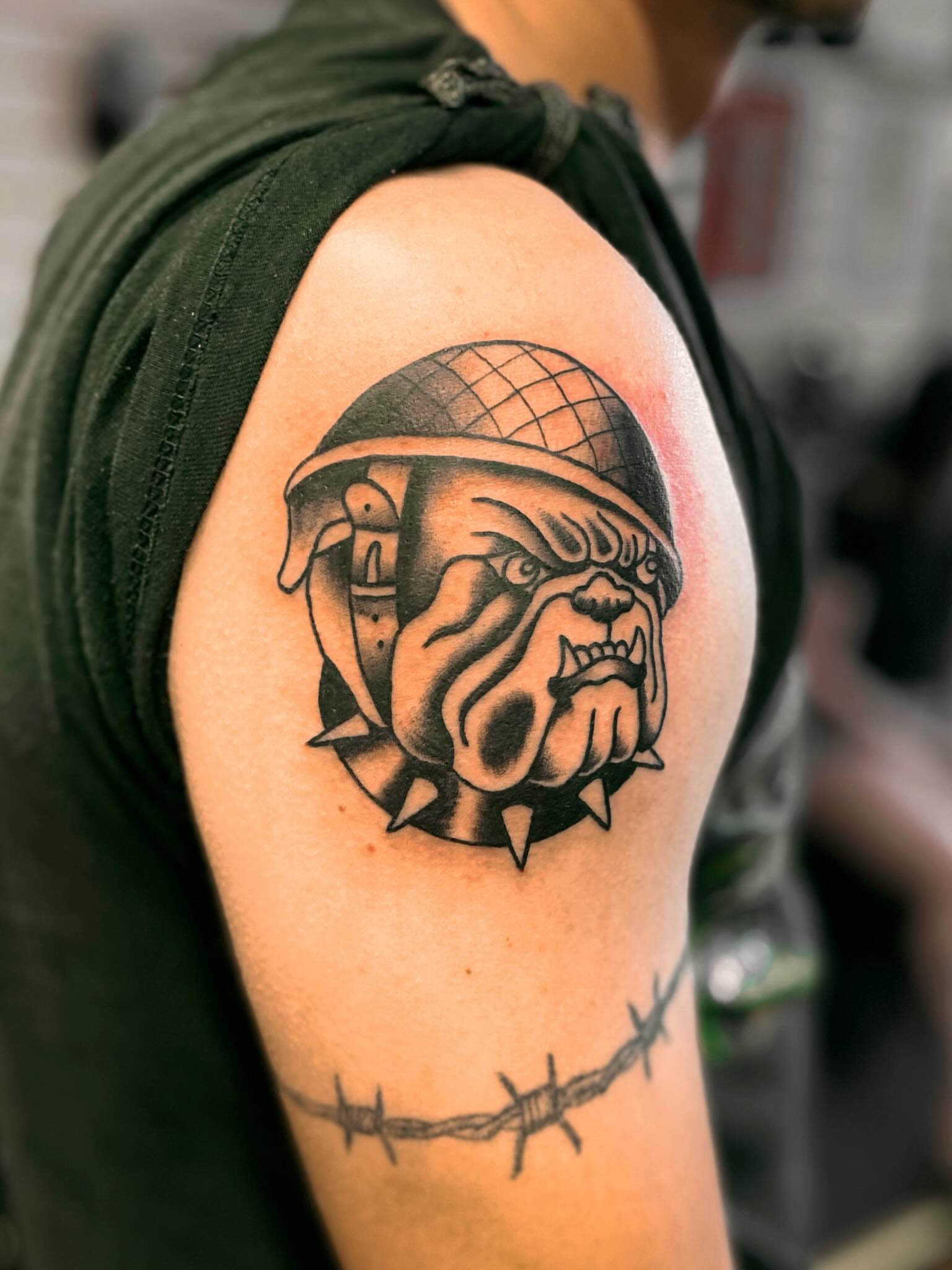 Bulldog helmet black and grey tattoo on the shoulder by Tommy O'Connell