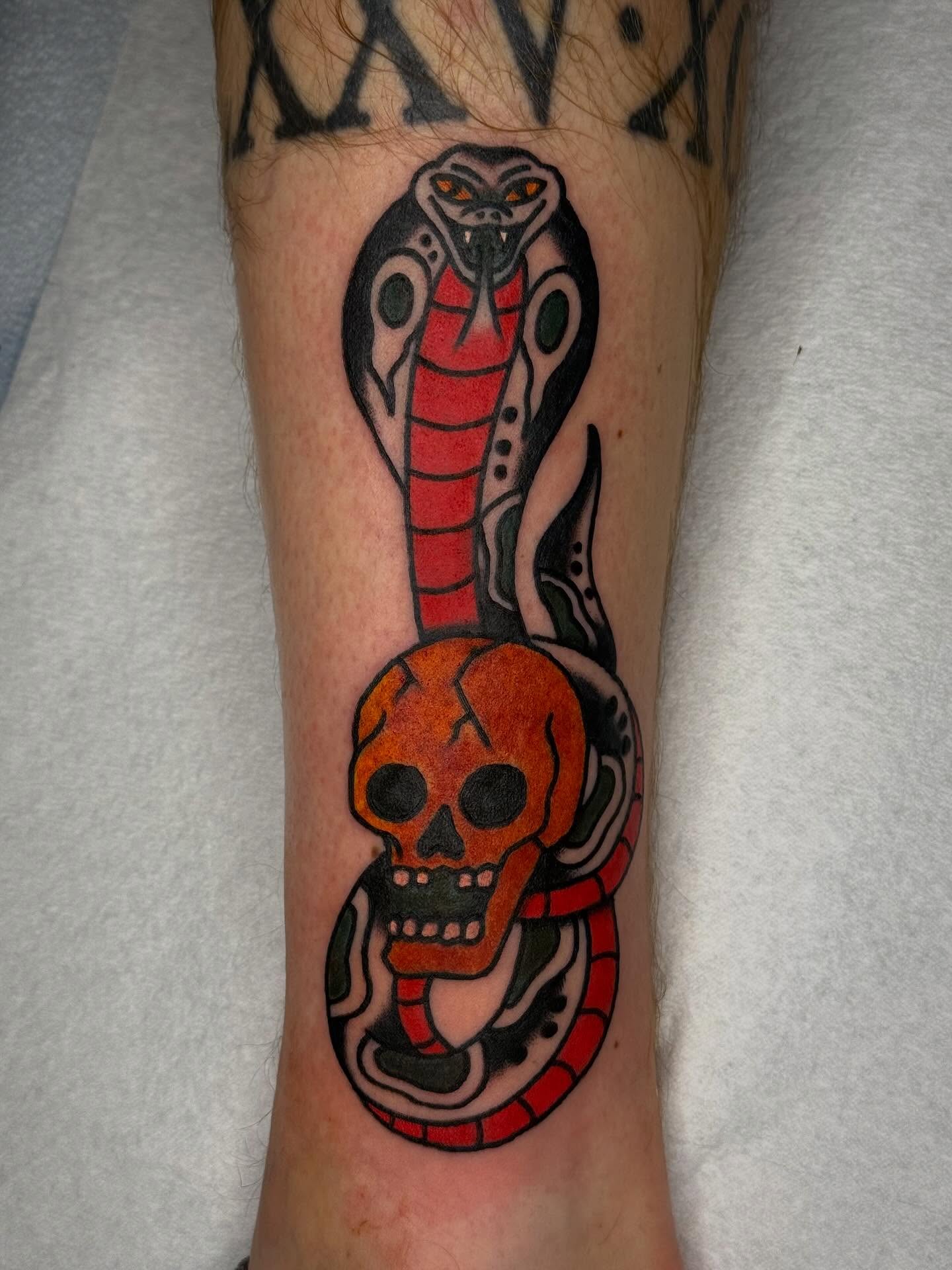 Snake and skull American traditional tattoo on the forearm by Clayton - TRADITIONAL TATTOOS