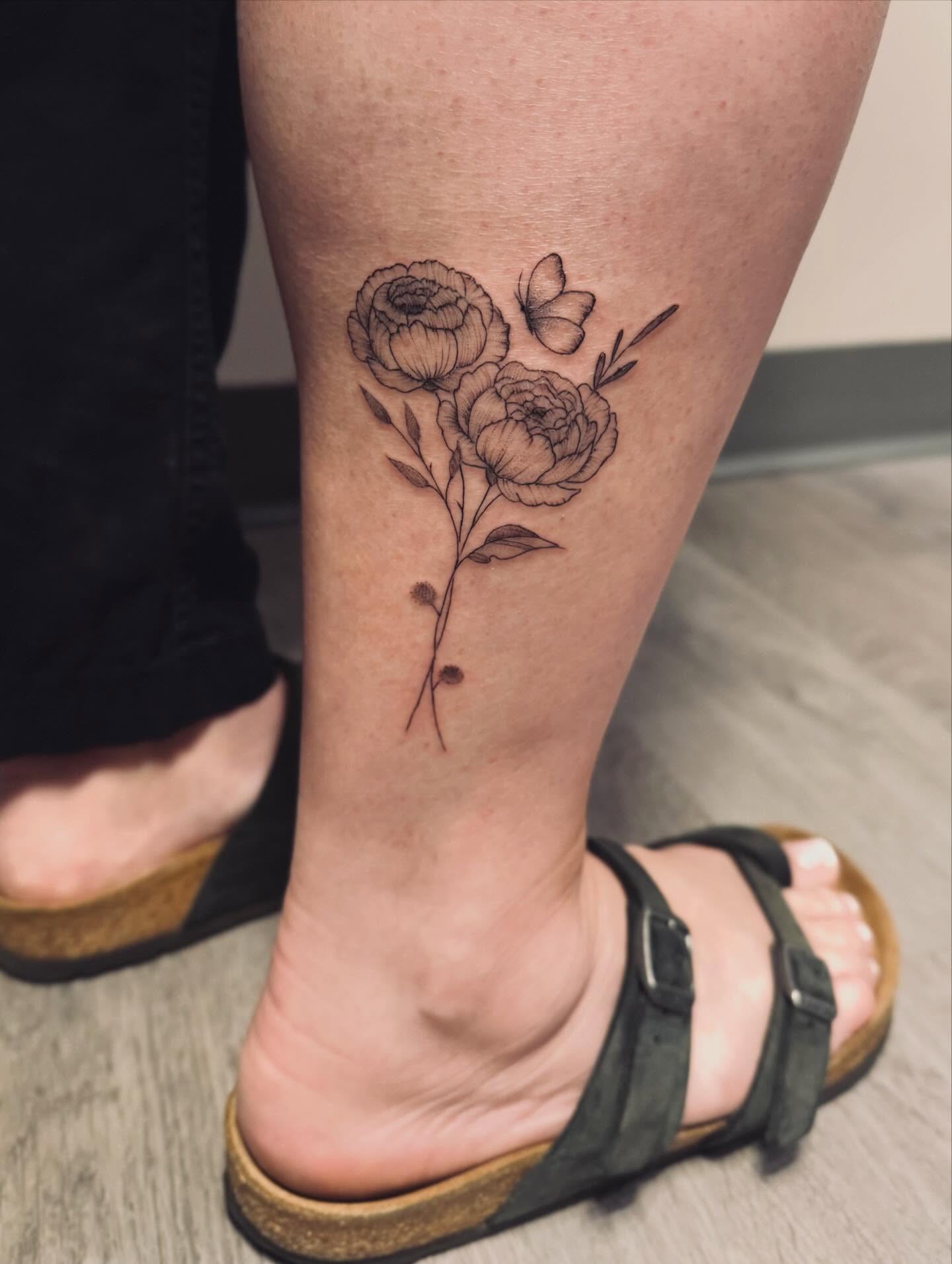 Peony flowers black and grey tattoo on the calf by Ashley Pilgreen
