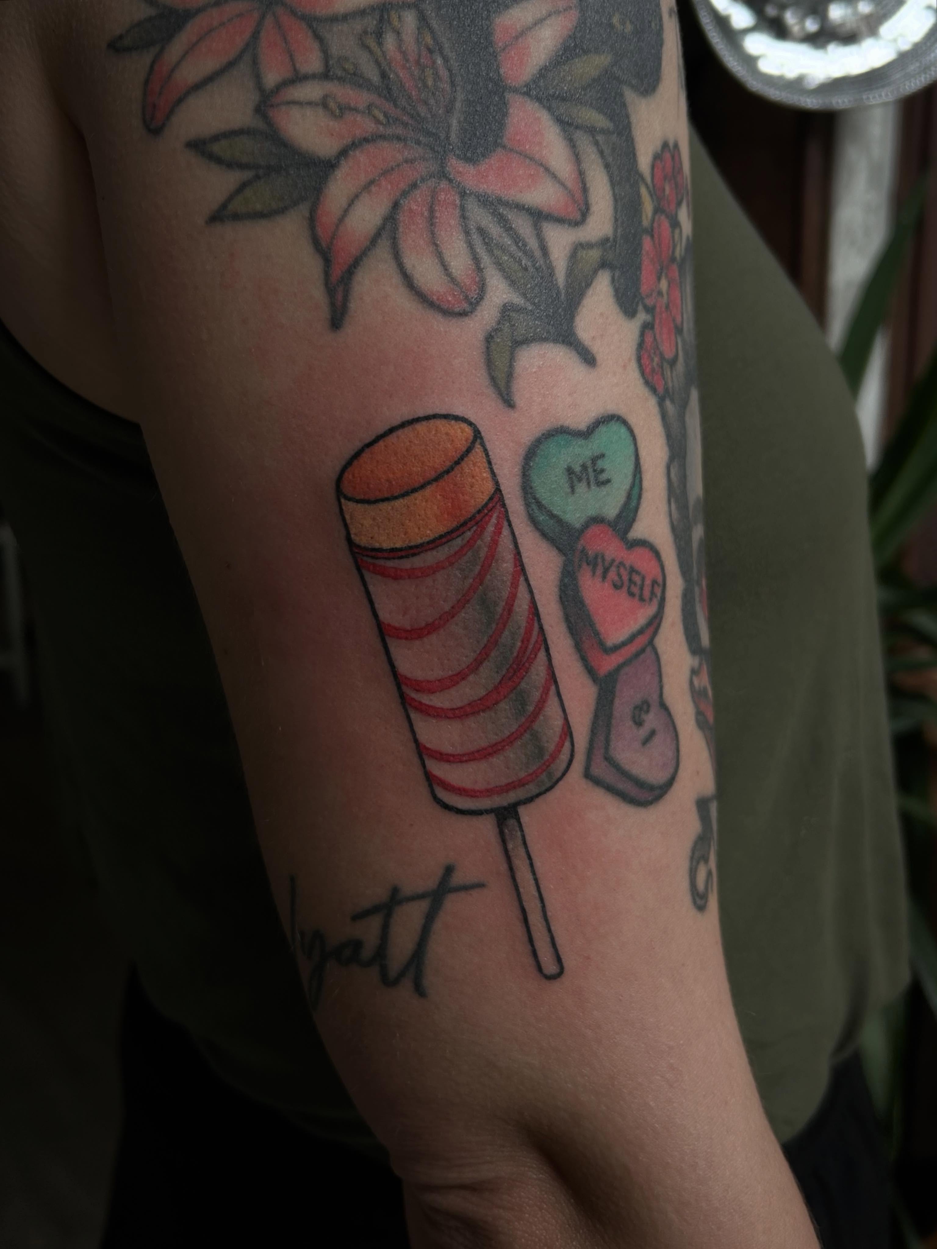 Lollipop and hearts new school tattoo on the forearm by ꧁𝙺𝚊𝚛𝚒𝚗𝚊꧂, Grinnell, Iowa