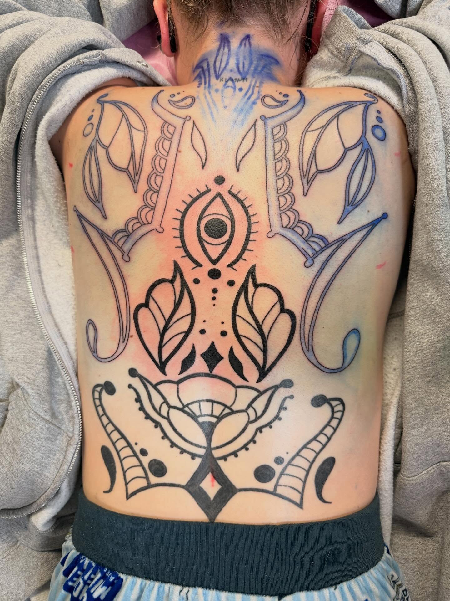 Geometric design geometric tattoo on the back by Scout Meyer