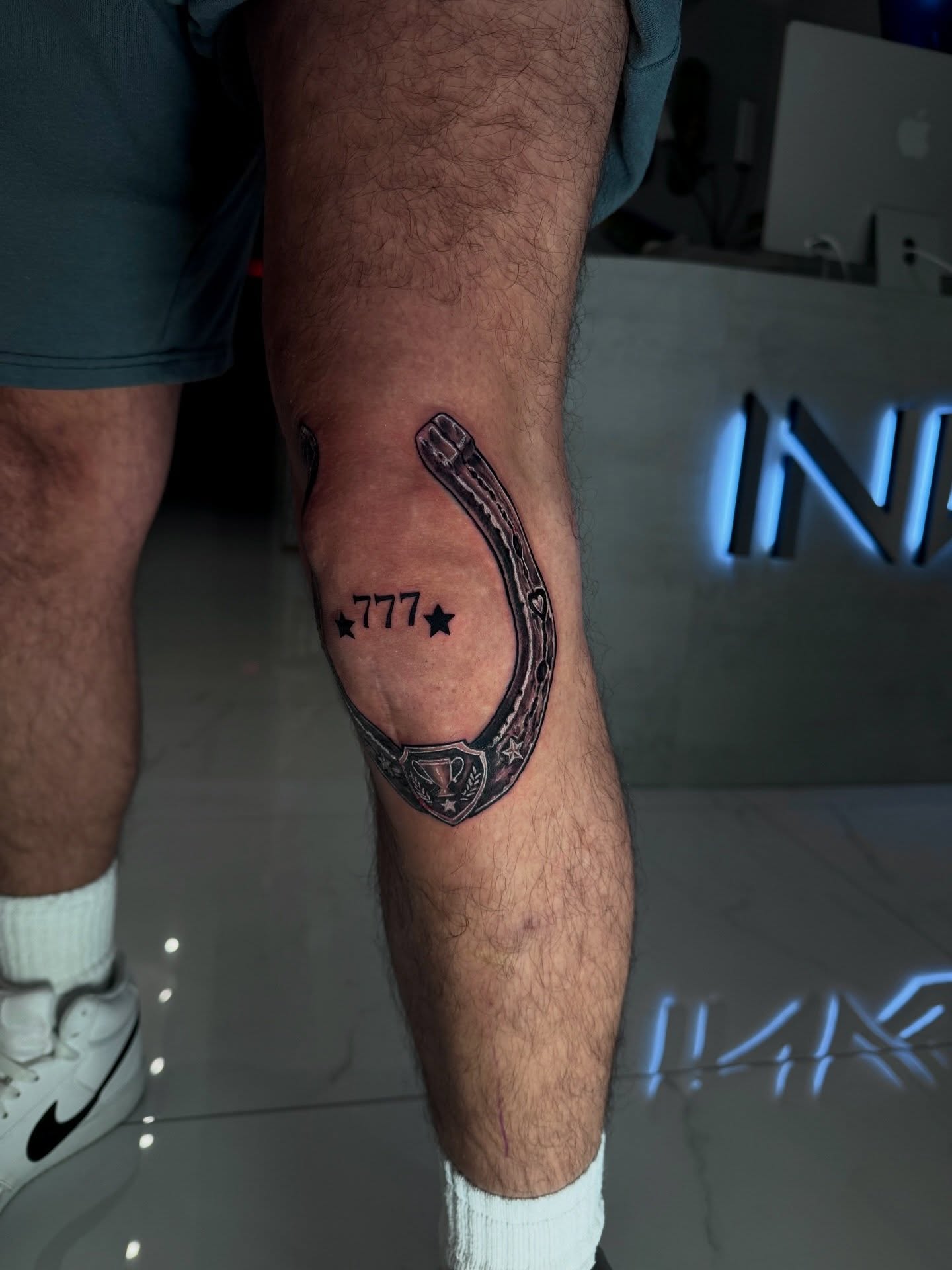 Horseshoe and stars black and grey tattoo on the calf by Alberto M