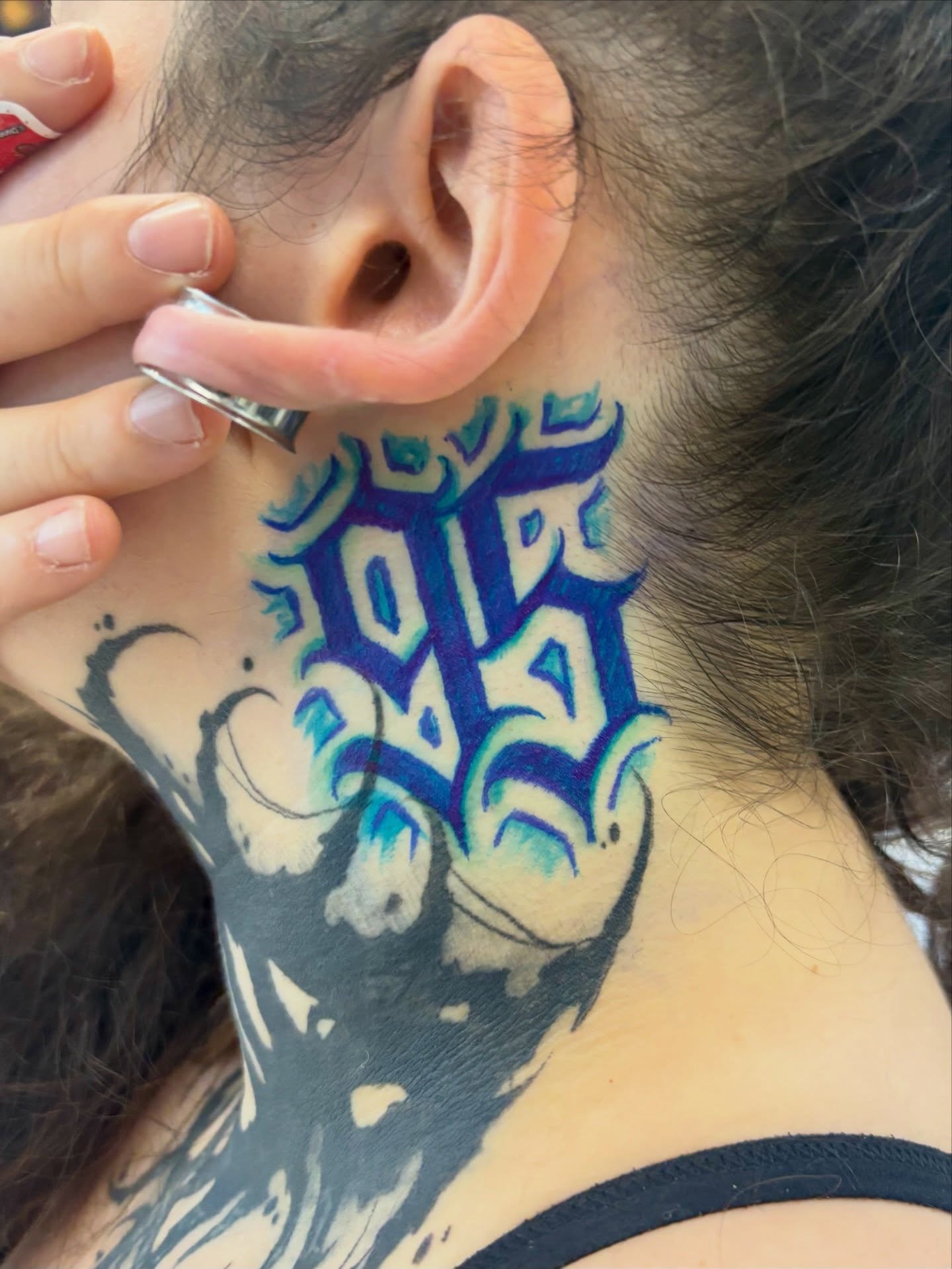 Graffiti-style lettering tattoo on the neck by Cristiano Ochoa, Elk Grove, California