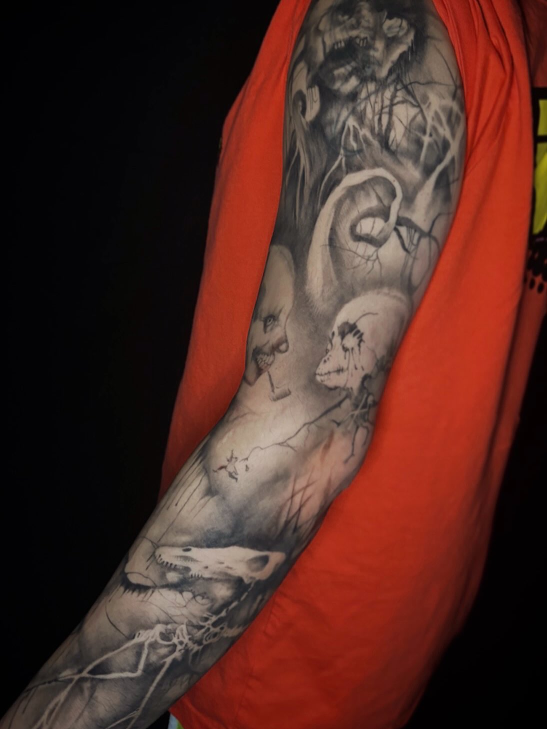 Monster and human dark realism tattoo on the forearm by Cassandra Colleen