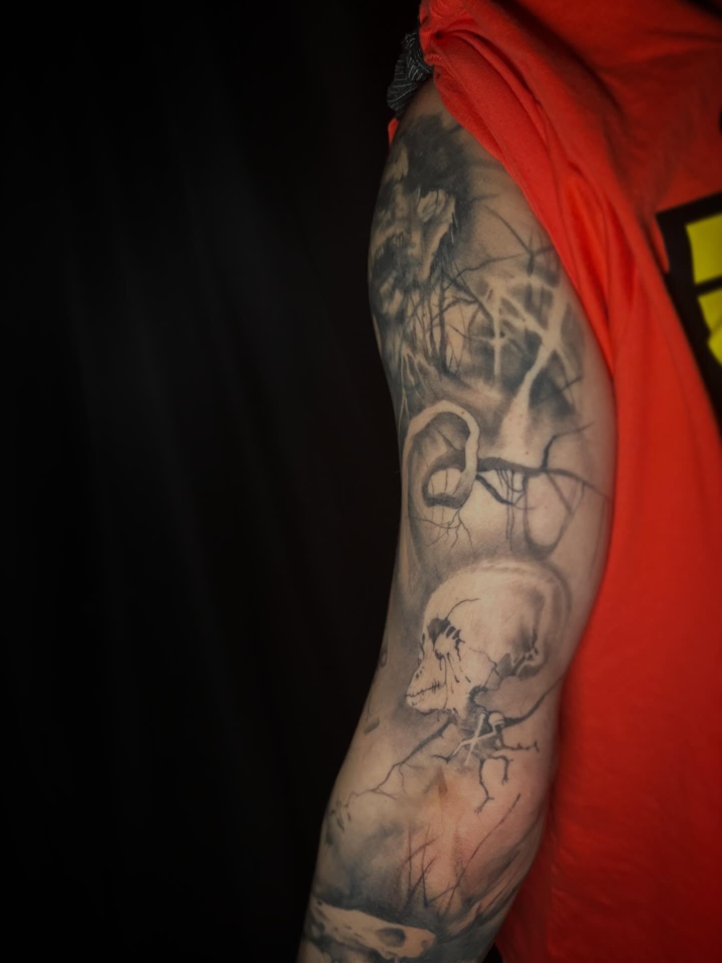 Skull and tree realism tattoo on the upper arm by Cassandra Colleen