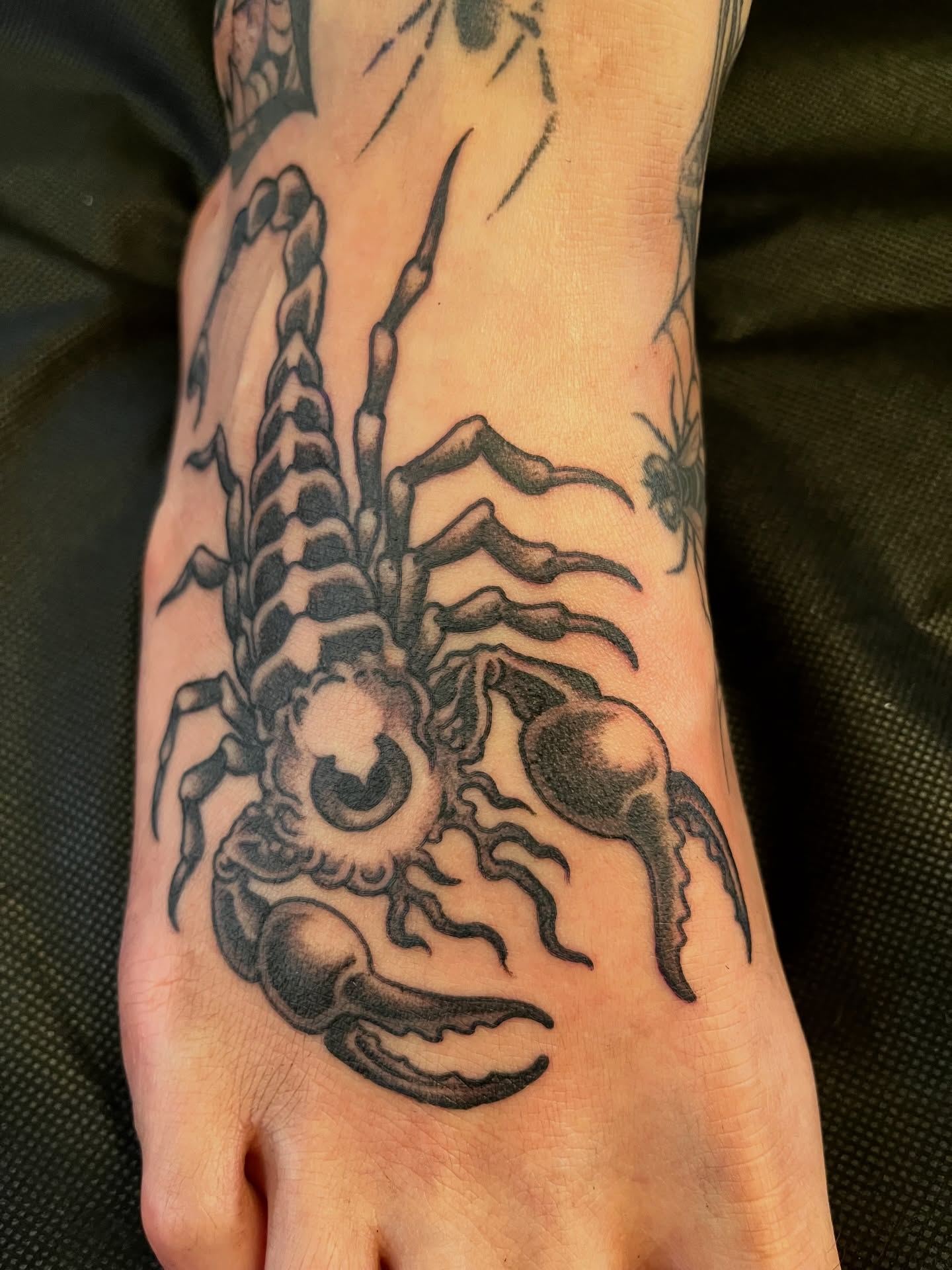 Scorpion black and grey tattoo on the foot by Campbell Zane Alexander