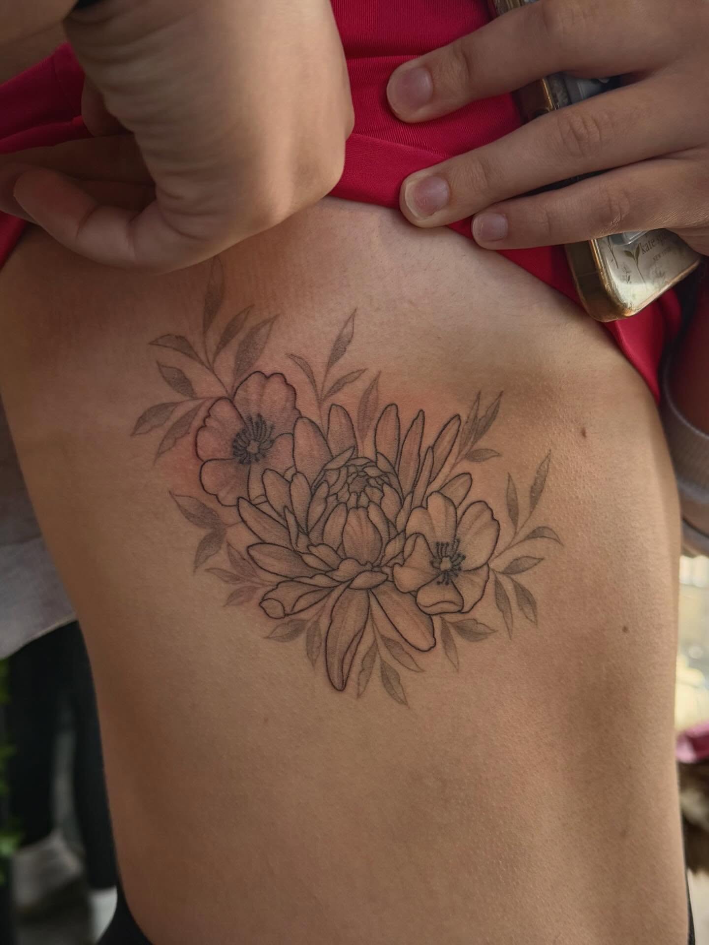 Floral bouquet black and grey tattoo on the ribs by Ashley Kayser