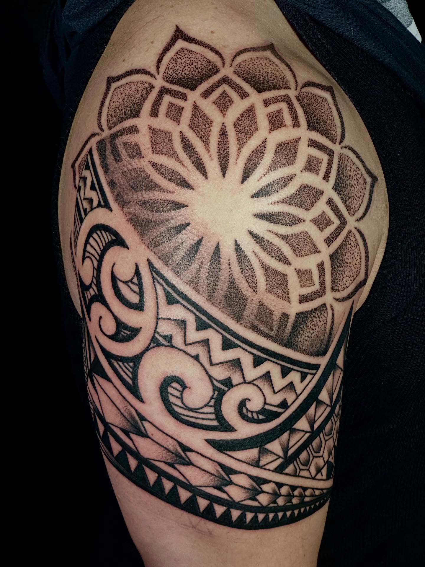 Lotus flower dotwork tattoo on the shoulder by Dylan Curry
