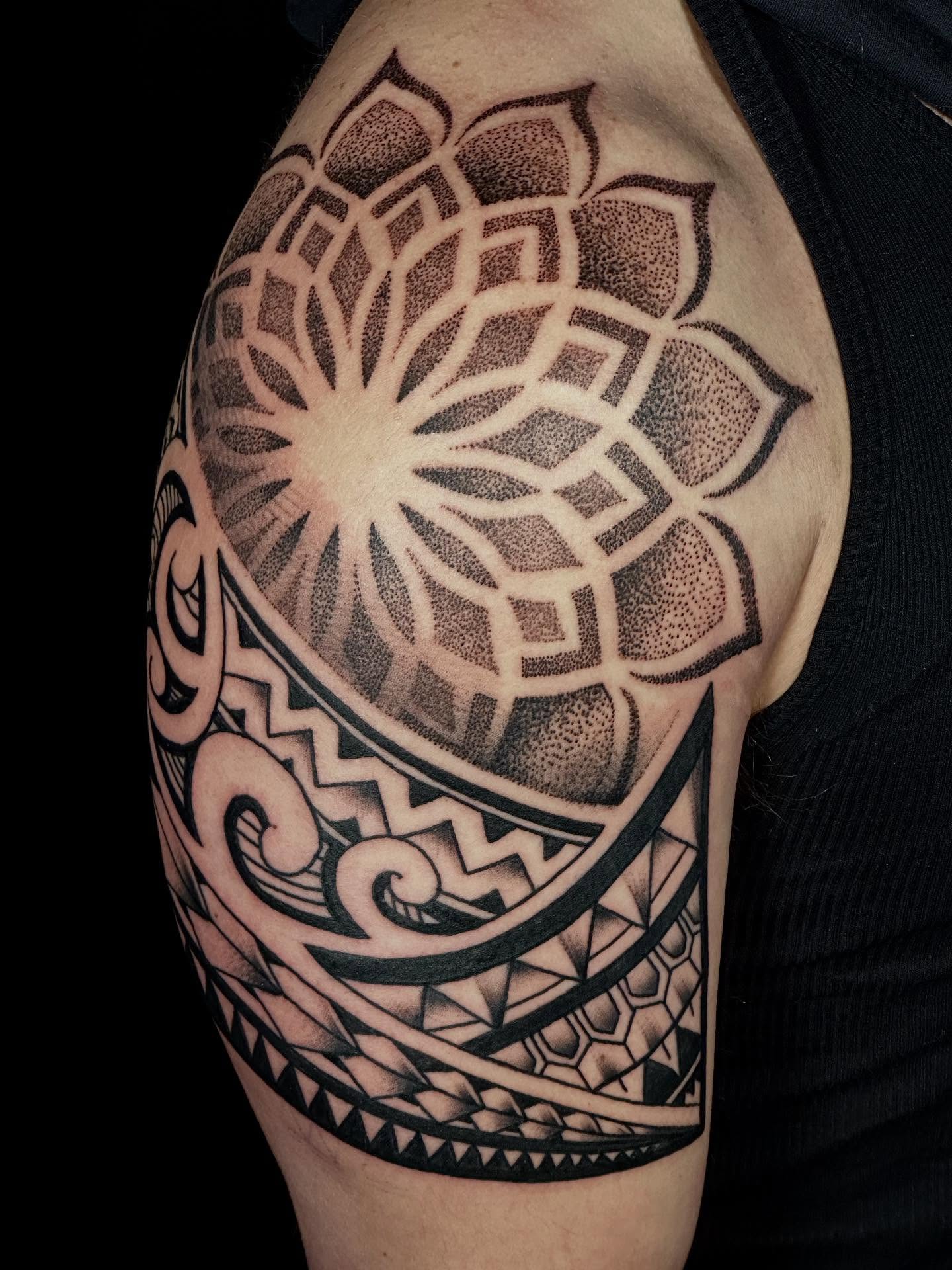 Lotus flower dotwork tattoo on the shoulder by Dylan Curry
