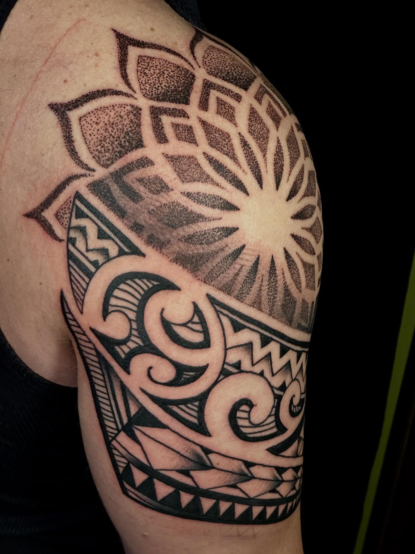 Lotus flower dotwork tattoo on the shoulder by Dylan Curry