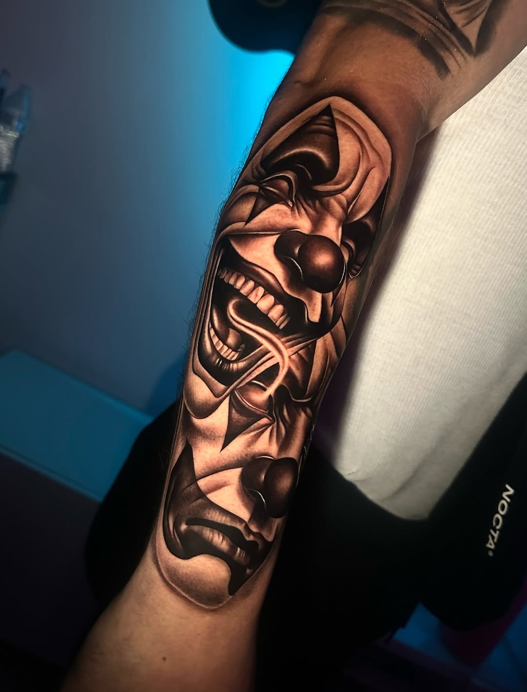 Two clown faces realism tattoo on the forearm by Emma Sferdian🇷🇴