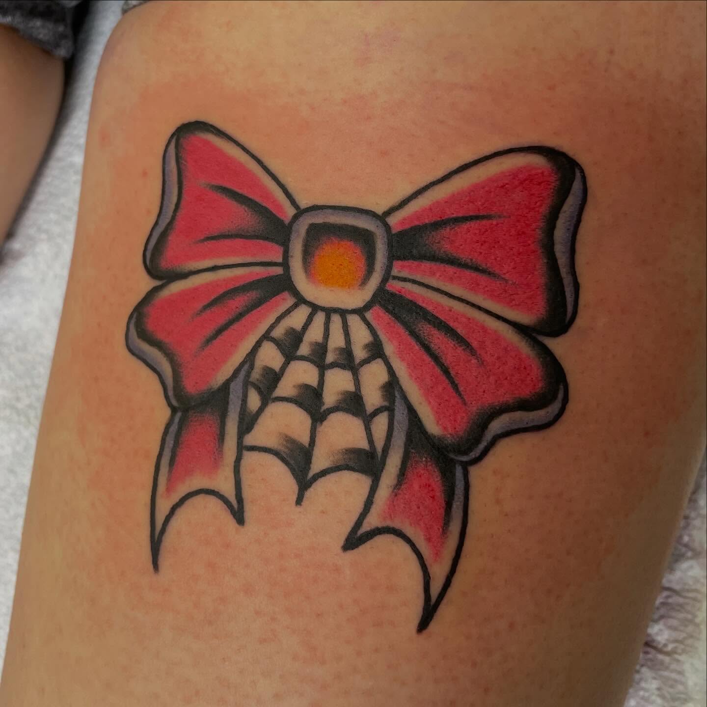 Bow American traditional tattoo on the thigh by Brandon Heredia, Vacaville, California