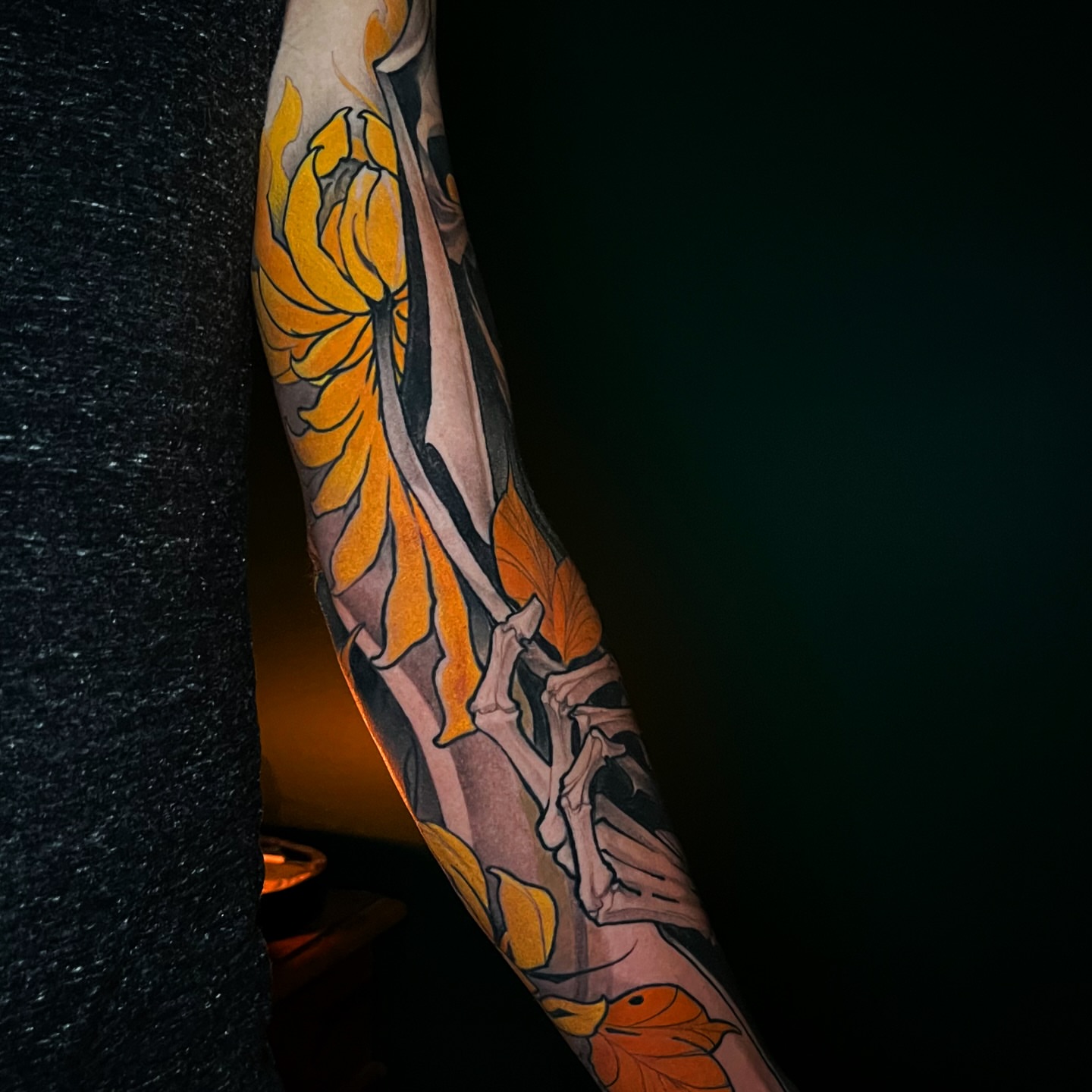 Sunflower and skeleton American traditional tattoo on the forearm by Joshua Weeks