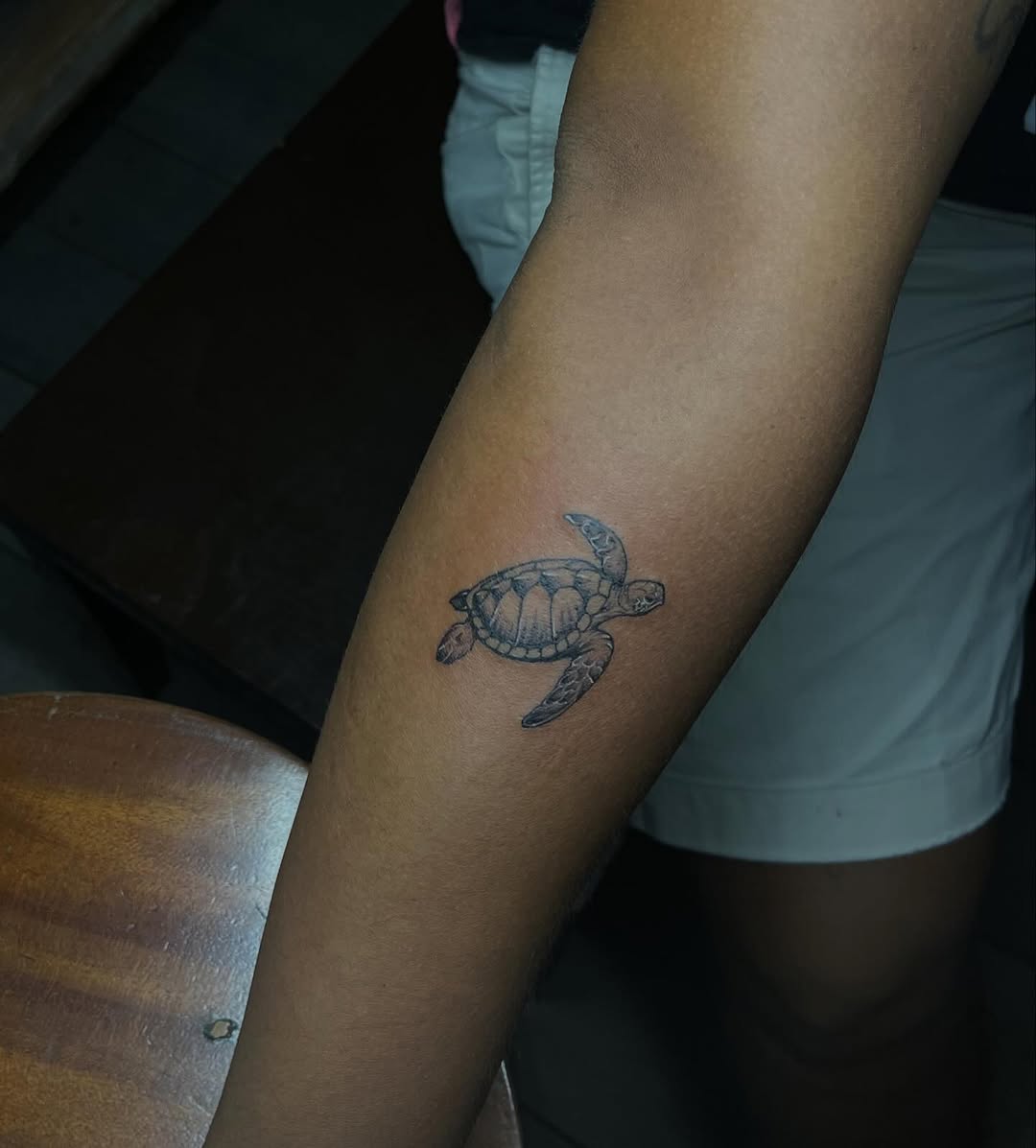 Sea turtle fine line tattoo on the forearm by Gerd thINK_TATTOO