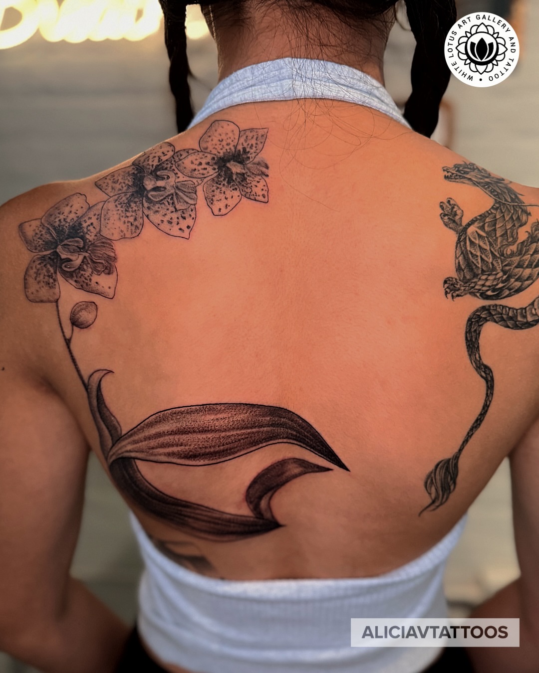 Orchids and dragon dotwork tattoo on the back by Alicia Vasquez