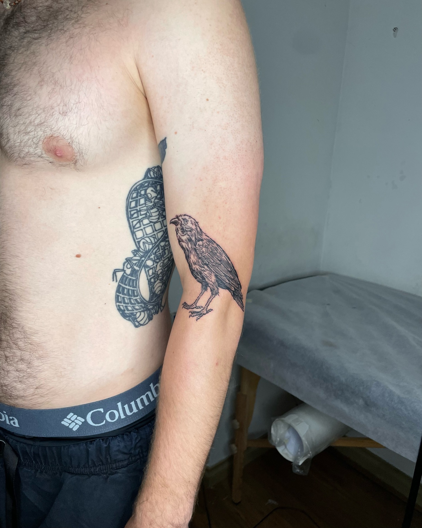 Crow black and grey tattoo on the upper arm by Anh Đan