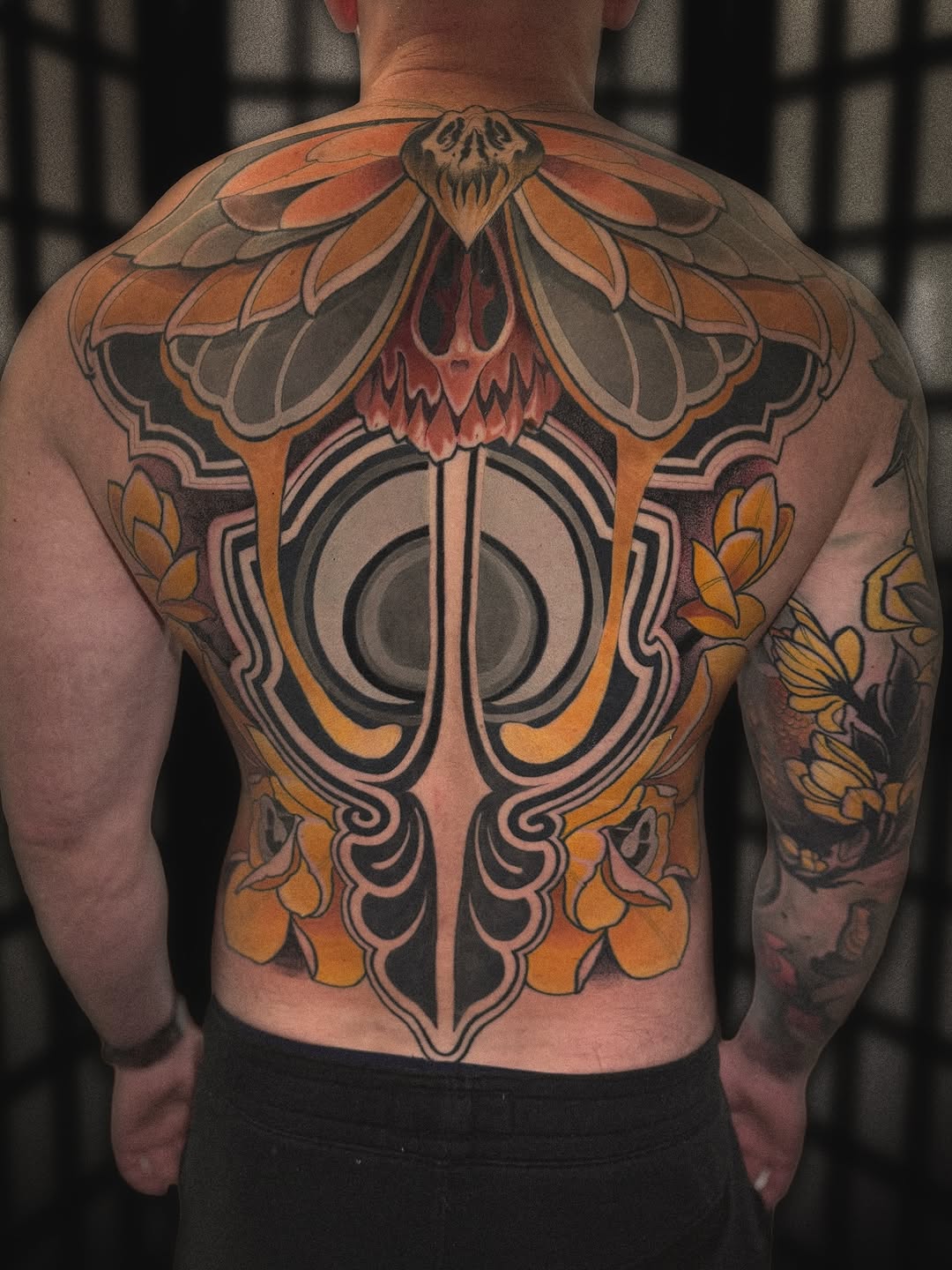 Moth and skull with floral elements tribal tattoo on the back by Matt - Neotrad Tattoos, New York, New York